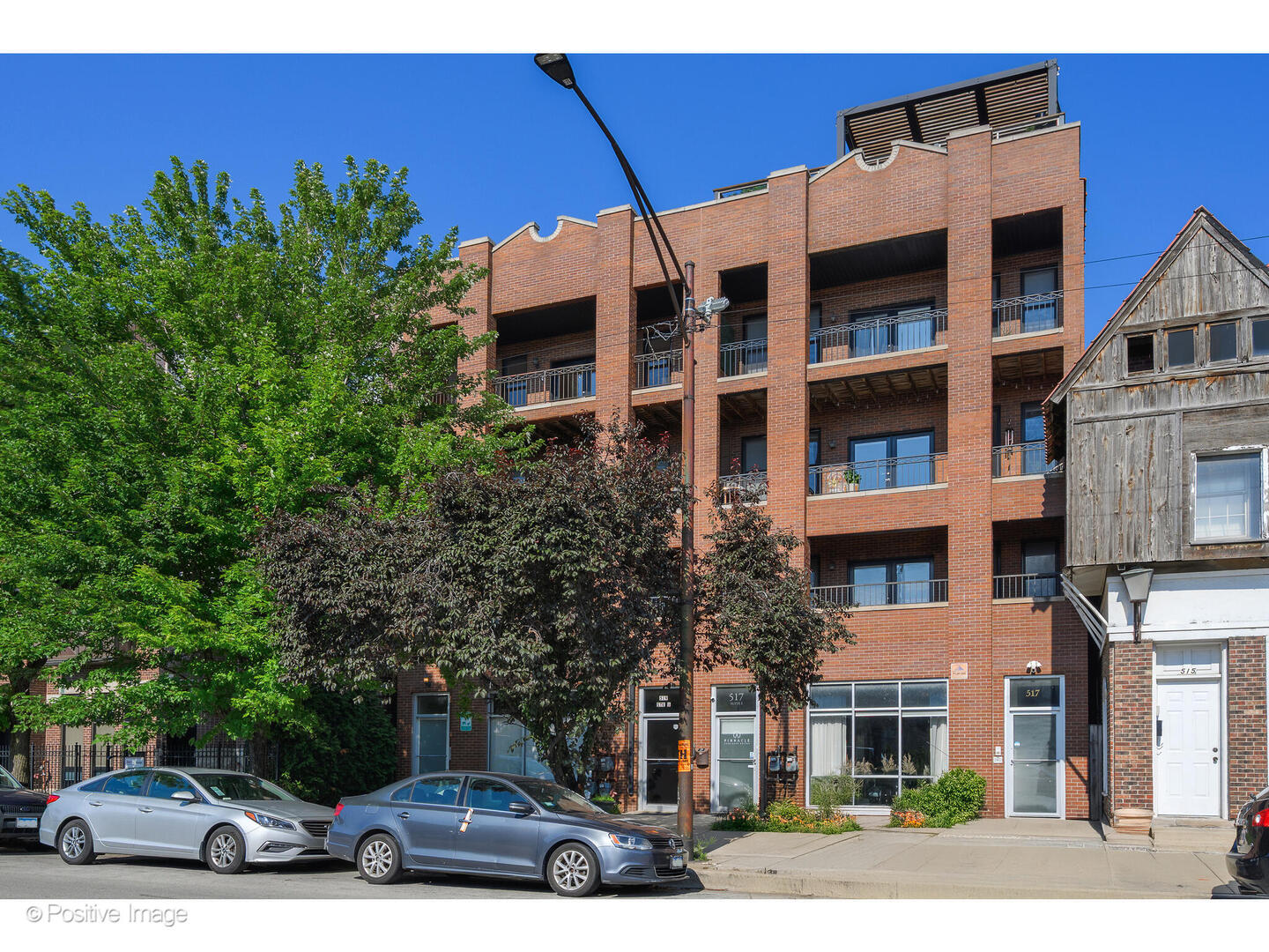 Nestled between the West Loop and West Town, this home is perfectly located near Noble Square and Ukrainian Village. This location has access to it all, including easy access to the Blue Line and the 90/94 expressway - a perfect locale for commuters. The extra wide layout allows for easy hosting and entertaining, with ample space for a large dining area and separate living area. The living room features a fireplace with built-ins on both sides for storage and display and access to a west-facing terrace that spans the width of the home. Completely open to the living area is the kitchen with all stainless-steel appliances, ample cabinetry, granite counter tops, and breakfast bar seating. Three gracious bedrooms, including the primary suite with dual sinks, separate tub and shower, a walk-in closet, plus access to an east-facing balcony. With easy access to multiple happening neighborhoods right outside of your front door, enjoy the best of all that Chicago has to offer! One garage parking space included.