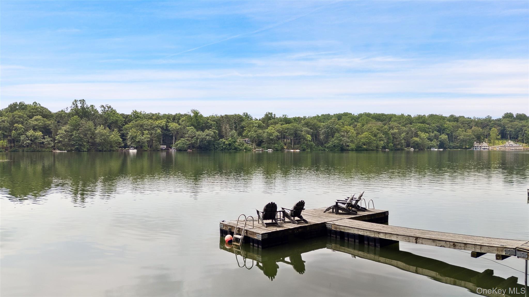 On the Shores of Lake Waccabuc. Absolutely amazing setting overlooking the water! Incredible Lakehouse offering true waterfront living with panoramic views. Originally built in 1939 and beautifully updated in 2015. Fabulous Living Room with vaulted ceiling, floor-to-ceiling stone fireplace and knotty pine paneling. Stunning open-layout Kitchen with dining and seating areas,  window walls and fabulous water views. Private Primary Suite with Dressing Room and luxurious Bath. Three additional Bedrooms. Private Office for working remotely. Multiple porches and decks allow for an easy indoor-outdoor lifestyle. Private funicular down to the lake with waterfront terrace, outdoor fireplace and large private dock. Incredible lake lifestyle with swimming, boating, paddleboarding and kayaking. First time offered in 30 years!