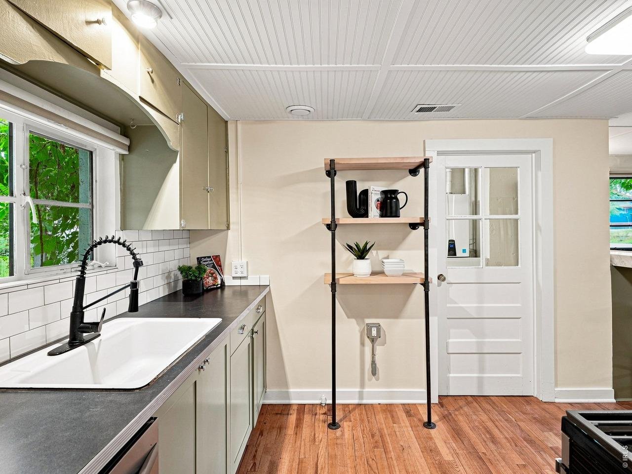 What if your morning started with breakfast at The Little, your afternoon included a quick walk to City Park for volleyball or pickleball, and fall Saturdays meant heading over to cheer on the Rams? Welcome to 408 S Washington Avenue, a rare Old Town West property that offers an incredible way to live now, with room to dream about what comes next. Set on an approximately 9,500-square-foot lot, the property is half a block from Dunn Elementary, an IB World School, blocks from City Park and CSU, minutes from Downtown, and just 20 minutes from Horsetooth Reservoir for those weekend boat days. Coffee, dinner, live music, CSU basketball and football are all within easy walking or biking distance. The move-in-ready, 699-square-foot, one-bedroom home has been freshly painted inside and out and features hardwood floors, an updated kitchen and bathroom, and a backyard that may be the best part of the property. Fully fenced and surrounded by mature landscaping, the outdoor space includes a covered pergola and two patios, creating multiple places to gather, unwind, or simply enjoy the Colorado seasons. Just beyond the main home, an approximately 134-square-foot detached flex space offers even more versatility. Separate from the reported living area and complete with a Murphy bed, it works beautifully as an office, studio, workout space, or creative retreat.Then there is the lot.With OT-A zoning, alley access, three off-street parking spaces, and approximately 9,500 square feet to work with, the property opens the door to a range of future possibilities, from a custom residence to additional living space, a garage, or an ADU concept. Future improvements are subject to City approval and buyer verification. A preliminary land-use analysis is available upon request This is the Fort Collins lifestyle people fall in love with: neighborhood coffee, live music under open skies, Tour de Fat through Old Town, fall weekends with the Rams, and summer afternoons at Horsetooth.