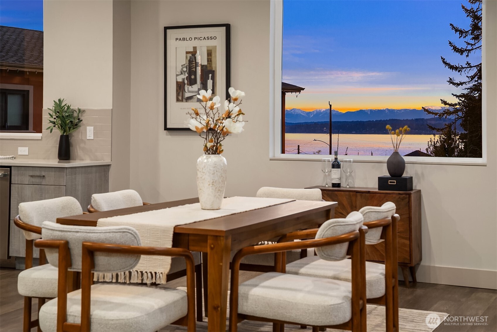 Richmond Beach living w/ stunning views & contemporary style Soaring 2-story entry welcomes w/ striking travertine accent wall. Generous open-concept design maximizes west-facing views of Sound & Olympics. Watch sunsets. Airy & light-filled throughout, main level features wide-plank hardwoods & gas fireplace framed by custom built-ins. Easy access to covered view deck for seamless indoor-outdoor flow. Gourmet kitchen showcases dual-tone flat-panel cabinetry & chef-grade Thermador appliances: 8-burner gas range. Spacious Primary Suite offers private balcony, sitting area, oversized WIC w/ built-ins & spa-like 5-pc bath. Upstairs family room & lower-level rec-room w/ $30K surround sound system w/ KEF in-wall & in-ceiling speakers. Updated landscaping w/ raised garden beds & accent lighting. 2-car garage. Mins to Kings, beach, & downtown Edmonds.