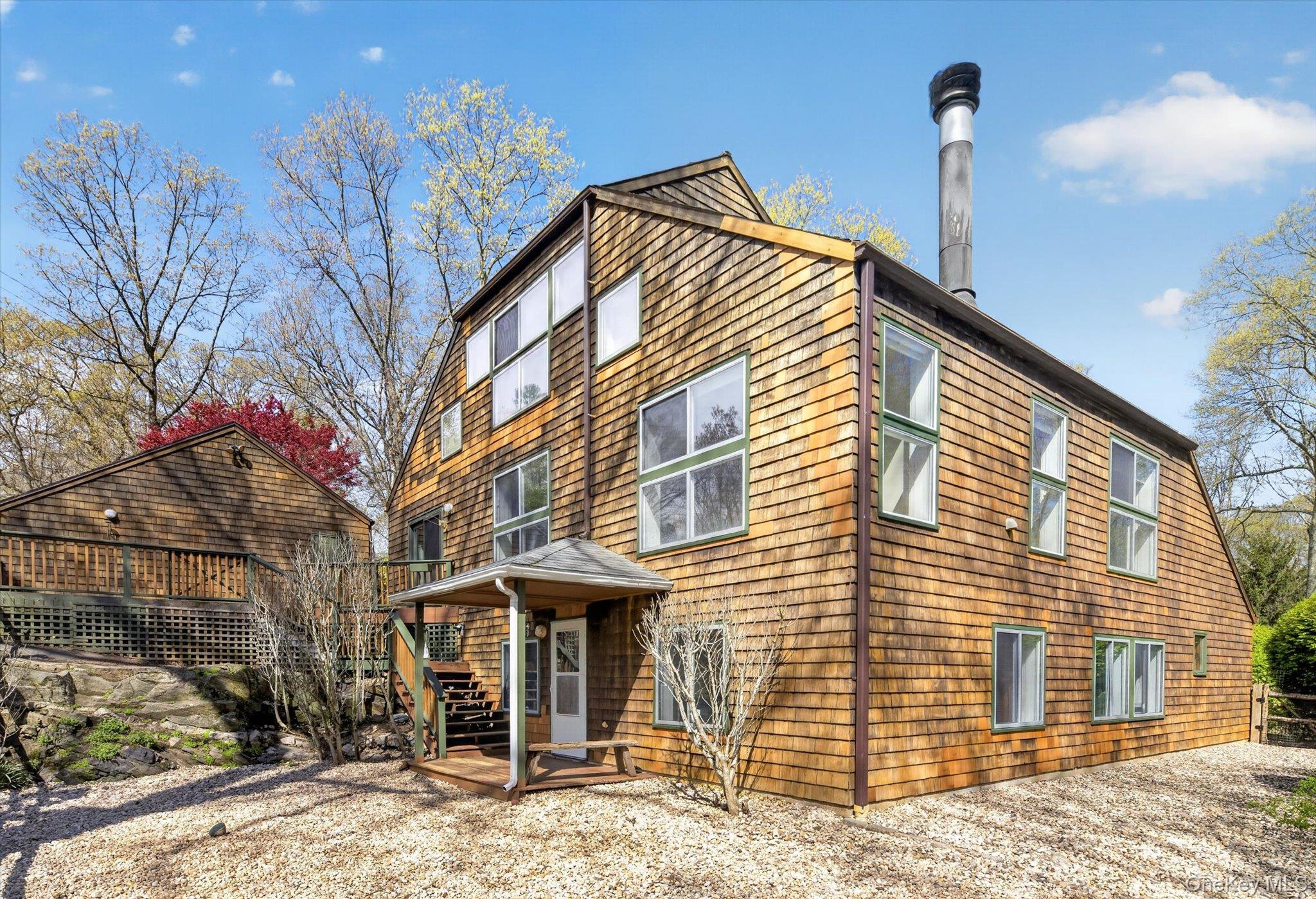 Tucked away on a quiet lane in North Salem, this one-of-a-kind contemporary home offers a rare blend of privacy, design, and natural beauty.  Set amidst a breathtaking perennial garden with meandering paths, the property invites you into a serene, zen-like retreat complete with a tranquil pool and hot tub.  Inside the approximately 2,900 square foot residence showcases an open, airy floor plan highlighted by abundant natural light, numerous skylights, and two fireplaces that anchor the living and dining spaces.  The kitchen flows seamlessly onto an inviting deck-perfect for morning coffee or effortless outdoor entertaining.  The home features four bedrooms and two-and-a-half baths, including thoughtfully designed details such as Japanese toilets.  An upper-level space provides flexibility for a home office or yoga room, adding to the home's versatility.  The grounds are equally captivating, with cleared areas ideal for vegetable gardening-where abundant harvests have thrived. The architecture evokes a timeless, Frank Lloyd Wright inspired aesthetic, harmonizing beautifully with the surrounding landscape.  Located just 55 miles north of New York City, this property offers convenient access to trains and major highways, making it ideal for both full-time living and weekend escapes.  North Salem's renowned equestrian culture and expansive open spaces further enhance the appeal of this exceptional offering.  A truly special and well maintained hidden gem - this home is where nature, design, and lifestyle come together in perfect balance.
