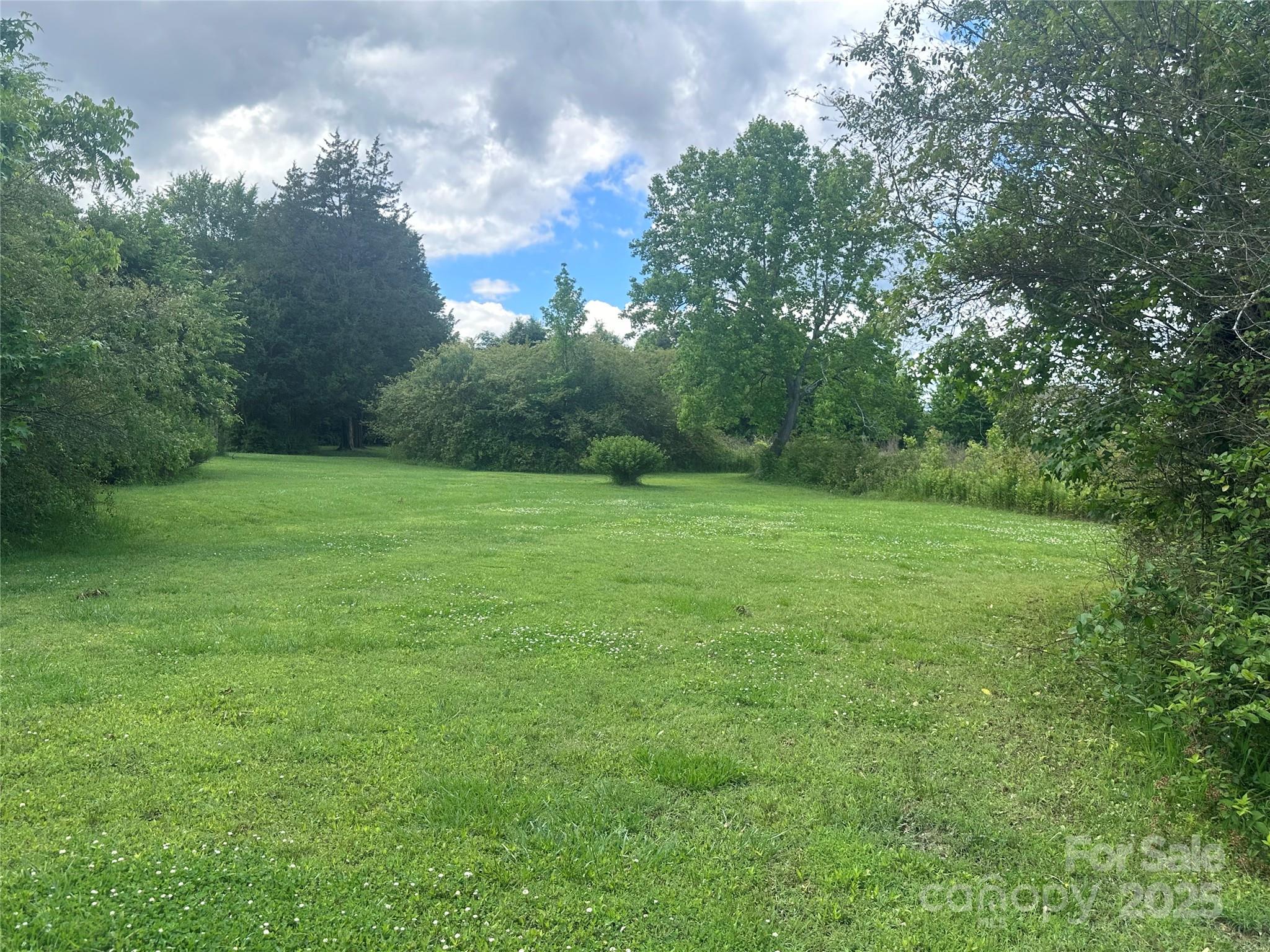 Charming, beautiful 5.37 acre tract at the corner of Mission Church Road and North Central Avenue (NC Hwy 200). Locust, NC. This is an old Homestead location in Western Stanly County. The property has mature trees and rolling fields. Perfect for Estate location. There is an old house on the property and several sheds in a state of disrepair. Please do not try to enter house or buildings.  Buyer will have to demo old sheds & house at their discretion. This property is being offered "as is" ,access will be given to the inside of the house upon delivery of acceptable offer to purchase. Treated this as 'Vacant Land' as the house will not support mortgage financing .  Seller makes "No Representations" as to condition of buildings, wells, septic or other systems.  Do not enter sheds or house .  House is LOCKED UP!  DO NOT ENTER ONTO THE PROPERTY WITHOUT A REAL ESTATE BROKER, NO Self Tours! No value given to structures & Seller will NOT remove any debris from house, buildings or property.