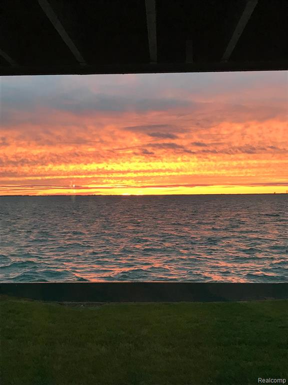HALF OFF INITIATION FEE UNTIL AUGUST 11! ACT NOW! Beautiful sunsets over Lake St. Clair! Fully updated 2 bedroom, 2 bath condo at Baypointe, an exclusive enclave within the private Old Club on Harsens Island (membership is required). First floor, interior unit in the north building with golf cart garage. Remodeled in 2017-2018 with granite countertops, new cabinets and new appliances in the kitchen. New paint, ceiling fans, and flooring throughout - LVT in living room, carpet in bedrooms, and tile in bathrooms. New vanities, faucets, sinks, and toilets in both bathrooms. Hunter Douglas silhouettes on all door walls. Cozy electric fireplace mantel with 55" TV in living room. Huge walk-in closet in master bedroom. New Pella Impervia fiberglass door walls with Low-E insulating glass on the bay side. New Trex decking on front and back decks. New water bag installed in 2021 for winter usage. New siding and roof on building. All furniture and furnishings negotiable. Buyer receives a deed. Buyers must be willing to join the Old Club, and sponsors can be found. Jet ski ramp near condo for sale too.