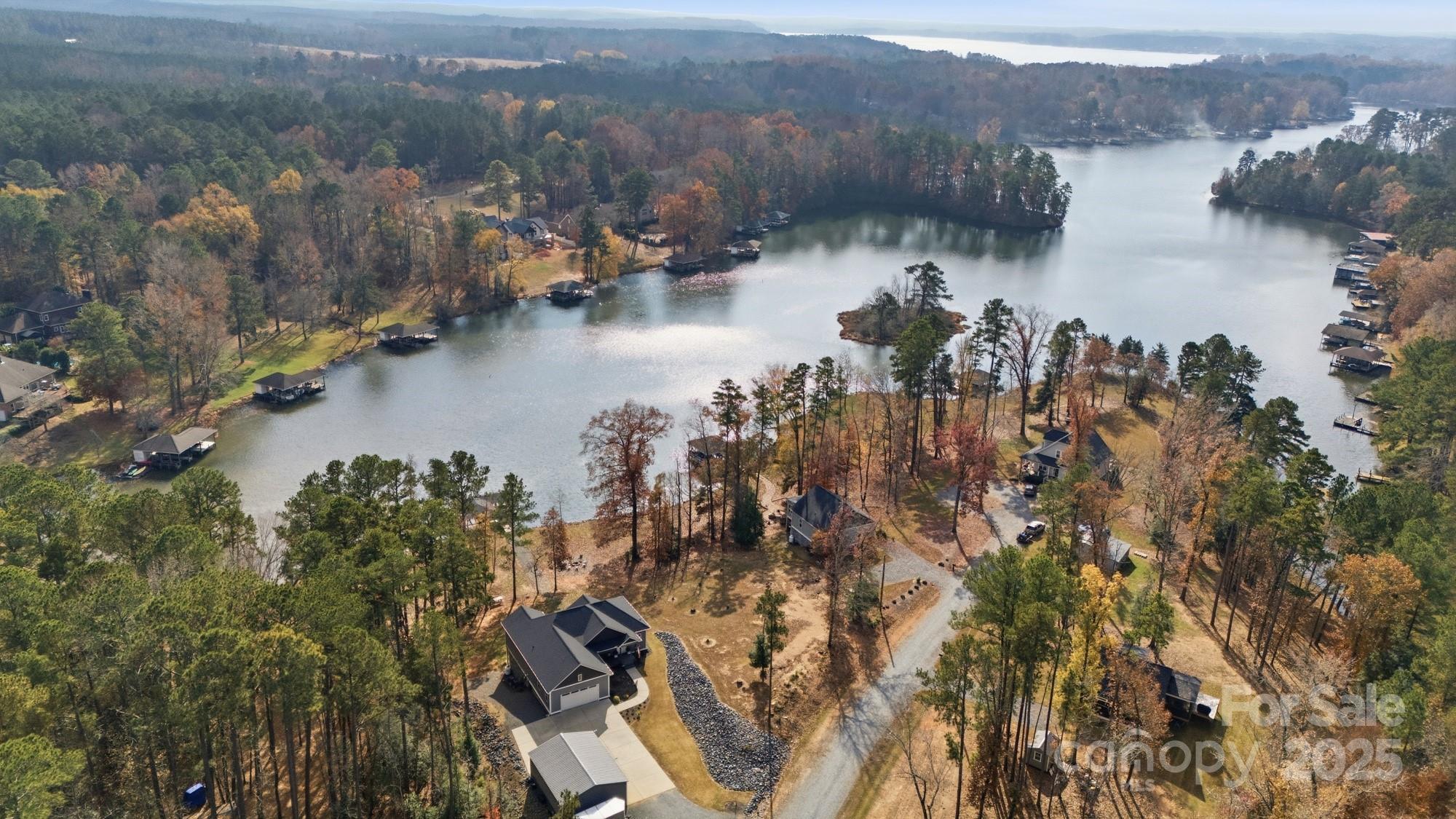 Discover a rare opportunity on Lake Tillery…a beautiful 0.31-acre waterfront lot in Emerald Shores, complete with another 0.30-acre off-site septic lot located just across the street. Together, these parcels offer 0.61 acres... the ideal foundation for your dream lake home without compromise. This waterfront lot features a gentle, build-friendly slope…a true advantage in an area known for steeper terrain. It’s perfectly suited for a basement-style home, where the lower level can open to a convenient walkout with an easy, natural grade down to the water. The serene, wooded surroundings frame long afternoons on the lake and picturesque views. Whether you’re envisioning a weekend getaway or a full-time residence, this property offers a rare blend of flexibility, natural beauty, and privacy… yet remains close to everything Lake Tillery has to offer. Bring your builder and imagine the possibilities… opportunities like this don’t come often.