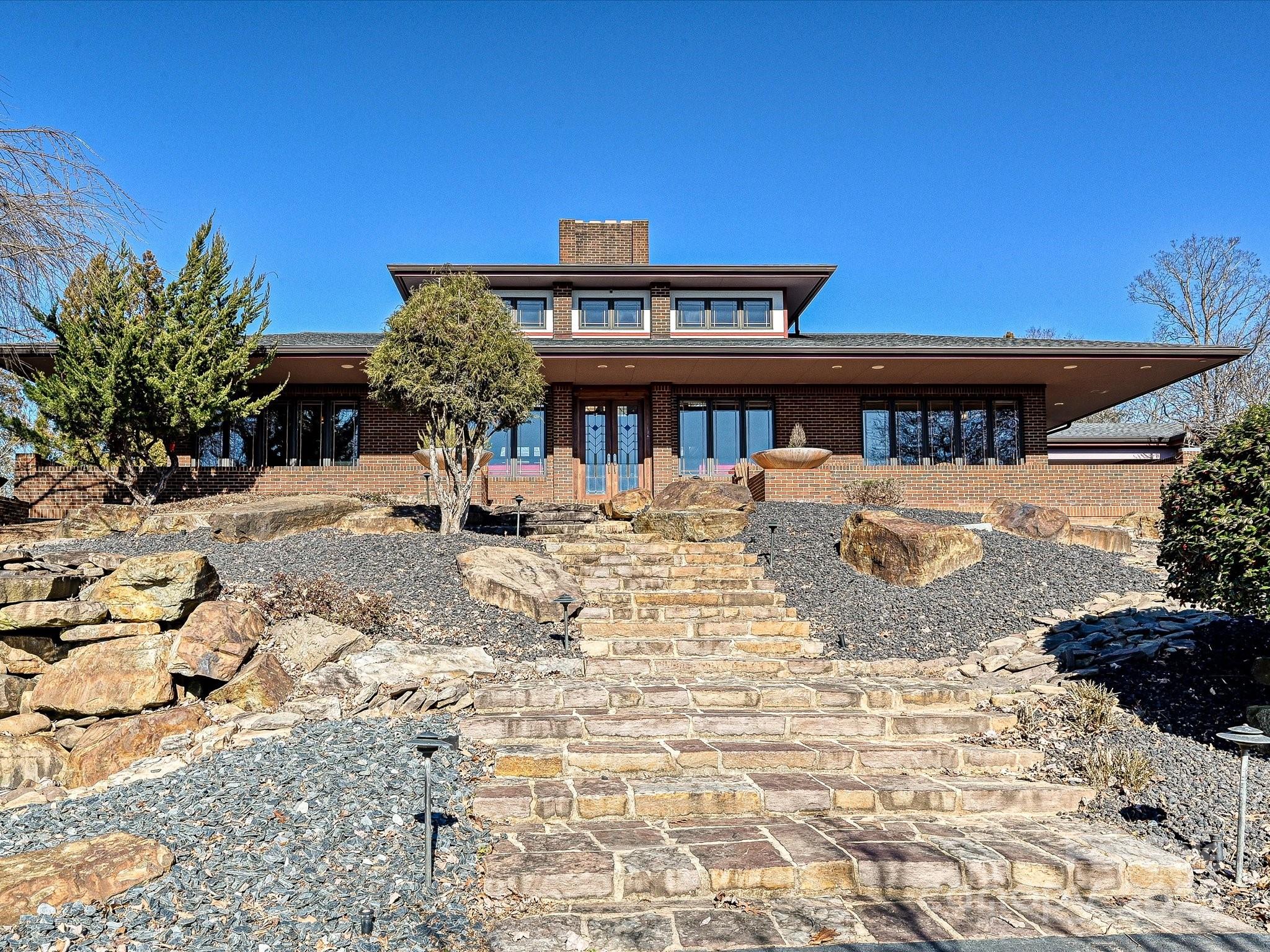 This remarkable NC equestrian retreat boasts equal delights for humans, horses, & dogs. Ingeniously integrated into natural surroundings, the Frank Lloyd Wright-inspired Prairie style estate presides over sculpted grounds, pastures, ponds, barns & English Gardens. The hub of the home is the great room, with soaring stone fireplace,17-foot ceiling & view to the atrium, creating the illusion of outdoor living indoors. Guest suites, kitchens up & down, 9-seat media room, wine & billiard rooms. Crafted pathways wrap around pool, koi pond, outdoor kitchen. Recreational or competitive horse people will appreciate the turnkey equestrian facilities with miles of board fencing, large indoor arena, total of 12 stalls, main barn, tackrooms, run-in sheds. Garages for 5 cars, huge machinery barn, spa dog kennel. This private paradise is near Baden Lake & Old North State Club's premiere golf, marina & club amenities. One hour to Charlotte, centrally located for Southeastern equestrian show venues.