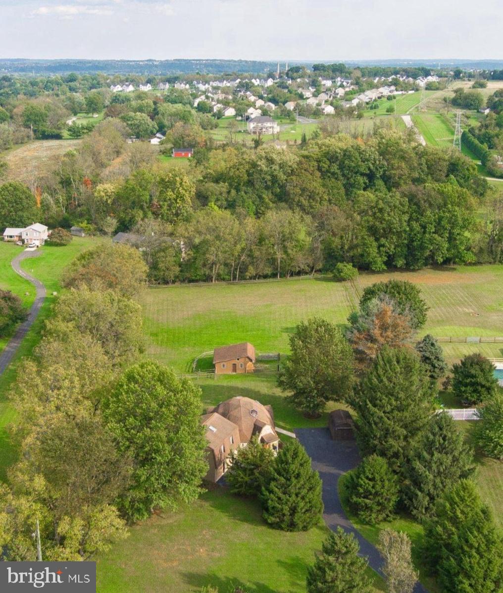 One of a kind!!! Rare opportunity to own a Buckminster Fuller-inspired geodesic dome home, privately situated on a lovely 2.5 acre parcel, with three stall barn and fenced pasture, framed by mature evergreen and deciduous trees.  This unique three bedroom, two full bath property is optimally located within close proximity to vibrant downtown Phoenixville, Kimberton Village, the Kimberton Waldorf School and award winning OJR schools, and is less than 30 minutes to Paoli's regional and AmTrak train lines to Philadelphia, NYC and DC.  The geodesic dome design, conceived in Germany but patented in the US in 1954 by Buckminster Fuller, employs an "omnitriangulated" network that distributes structural stress more efficiently than the standard rectangular dwelling.  The resulting spherical shape enhances energy efficiency by creating an even, natural airflow for both hot or cool air to circulate...Originally constructed in 1979 and then expanded in 1992, the home features compelling mid-century architectural details, most notably the series of pentagonal skylights within the dome, and a spiral staircase that accesses a lofted area with incredible skylight views, as well as views down to the circular main level floor plan...Enter through the main door into the foyer, which is flanked by two coat closets, and then leads past the spiral staircase into the living room, illuminated not only by the domed skylights but also by a large picture window.  The living room seamlessly flows to the dining area, with built-in cherry cabinetry and sliders to the patio, yard and pasture beyond.  The adjacent, updated kitchen, designed and installed by Dilworth's Custom Design, features Cambria quartz counters, cherry cabinets, stainless appliances and recessed lighting.  From the both the kitchen or entry foyer, take the main hallway to the first full bath, with walk-in shower, detailed tile floor and vanity with granite counter top, then further down the hallway find a well-sized main level bedroom.  Rounding out the main level is a combination mudroom / laundry room, with coat closet, egress to the rear exterior of the home as well as convenient egress to the attached, oversized two car garage.  The whole main level has absolutely everything you'll ever need for one level living, now or in the future....The home's floorplan also includes two upper level areas - the first, within the dome, is a lofted space open to the dome and floor plan below, along with a fully enclosed 14' x 12 ' bedroom with skylight.  The second upper level is accessed via stairs from the laundry / mudroom, atop which is an expansive and private primary suite, with attached full bath, large walk-in closet and sitting area with sliders to a dedicated balcony within the treetops, providing beautiful views of the yard and pasture beyond...Outside, find a tidy three stall barn with water and electric, as well as a fully fenced pasture, and a large shed for convenient additional storage.  The rear patio is fully wired and waiting for your hot tub - no better place to enjoy moon and stars and winter snow falls !!! ....This singular property, well loved and maintained by the current owners over their 38-year stewardship, now beckons its next lucky owner - come see all this special property, in an exceptional location, has to offer!!!!
