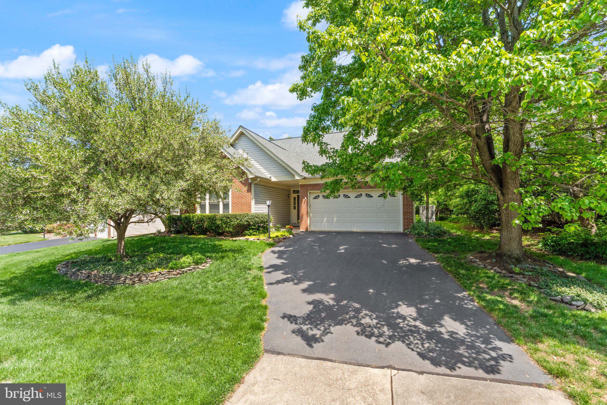 Nestled within the highly sought-after Ashburn Village community, this charming and increasingly rare main-level living home offers 3 bedrooms, 2 full baths, and a spacious 2-car garage, all thoughtfully designed for comfort, convenience, and long-term flexibility. Backing to mature trees, the home enjoys exceptional privacy and a peaceful natural setting rarely found within such a vibrant amenity-rich neighborhood.Inside, soaring ceilings and dramatic “open to below” architecture create an airy, light-filled atmosphere throughout the main living spaces. The open-concept layout seamlessly connects the living room, dining area, kitchen, and breakfast nook, offering an inviting flow ideal for both everyday living and entertaining. The spacious main-level primary suite provides privacy and convenience with an en-suite bath and walk-in closet, while two additional bedrooms offer flexibility for guests, home offices, wellness spaces, or hobbies.Upstairs, versatile loft and bonus spaces add even more functionality, adapting easily to a variety of lifestyle needs. Outside, the expansive patio overlooks mature trees, creating a serene outdoor retreat perfect for relaxing, entertaining, or simply enjoying the privacy of the natural surroundings.Residents enjoy access to the renowned Ashburn Village Sports Pavilion featuring indoor and outdoor pools, fitness center, tennis and pickleball courts, basketball courts, lakes, walking trails, playgrounds, sports fields, and year-round community events. Conveniently located near One Loudoun, the Washington & Old Dominion Railroad Regional Park trail, Route 28, Route 7, and the Dulles Greenway.Within a community of thousands of homes, true main-level living opportunities like this remain remarkably limited - making this a rare and highly desirable offering in Ashburn Village.