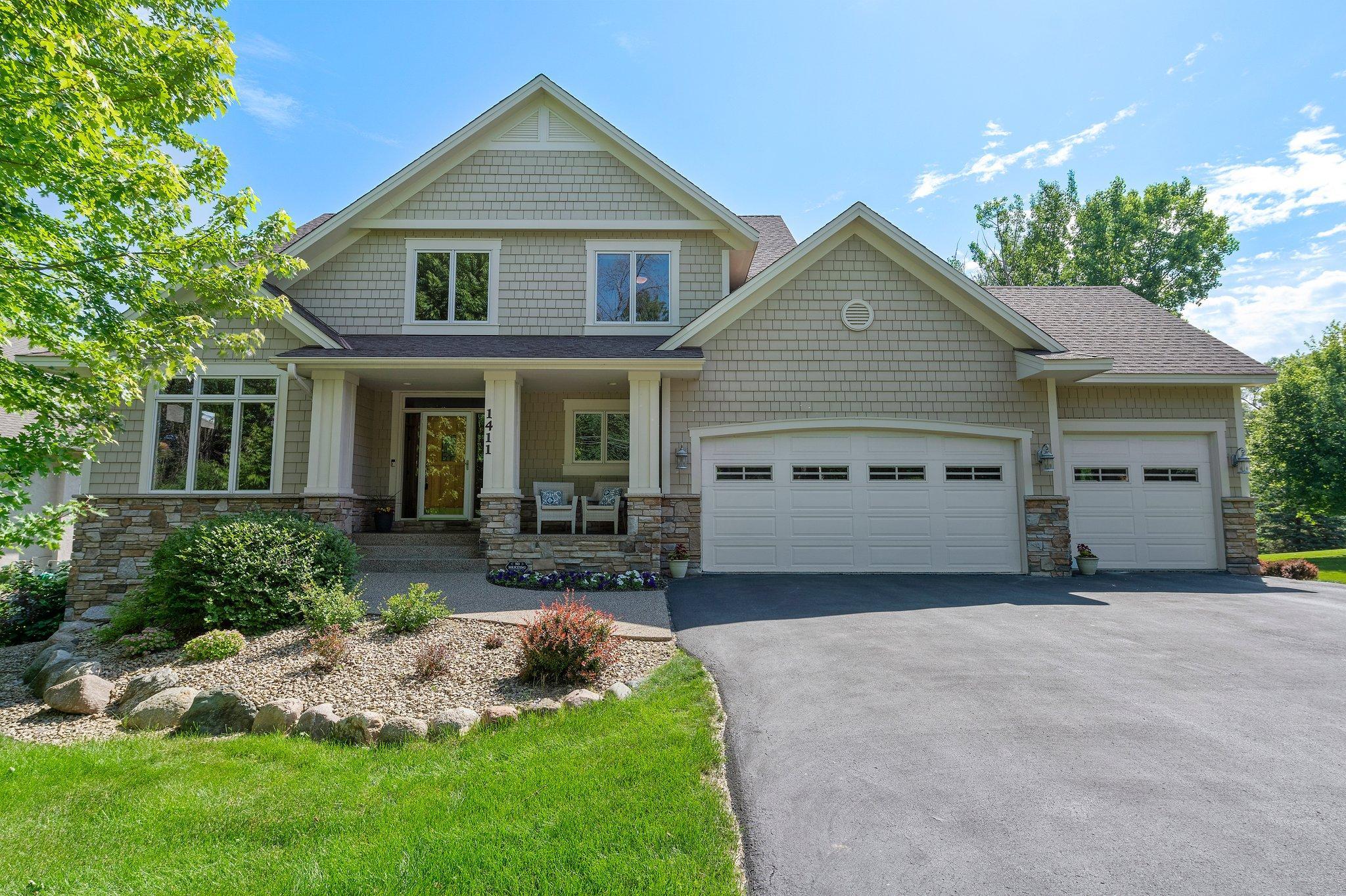 This stunning 5-bedroom, 4-bathroom home is nestled in one of Minnetonka’s most sought-after neighborhoods. Enjoy the convenience of being minutes from premier shopping, dining, and easy access to Highways 394 and 169—all while soaking in the peaceful beauty of nature right in your backyard. Inside, thoughtful design meets modern comfort. The chef’s kitchen features abundant maple cabinetry, sleek granite countertops, a spacious center island with breakfast bar seating, a stylish tile backsplash, and rich wood flooring. It flows seamlessly into the informal dining area, highlighted by a timeless chandelier and sliding doors leading to a 16x12 maintenance-free deck—perfect for indoor-outdoor entertaining. The formal dining room exudes elegance with wood floors, a chandelier, and large windows offering tranquil side-yard views. The main-level living room boasts plush carpeting, expansive windows overlooking the landscaped backyard and pond, and a gas fireplace with tile surround and built-in cabinets. A 55” Samsung Frame TV and built-in speakers on the main and upper levels elevate the entertainment experience. Just off the foyer, the main-level office offers a professional workspace with brand-new carpet, recessed lighting, natural light, and sophisticated wainscoting. The attached, heated 3-car garage includes built-in storage and leads to a well-designed mudroom with tile floors, lockers, and a bench. A central vacuum with kick-switch dust pans in the mudroom and kitchen simplifies cleanups. The main-level laundry room is both functional and stylish, offering ample cabinetry, counter space, tile flooring, a utility sink, and high-efficiency Samsung washer and dryer.
Upstairs, the spacious primary suite is a serene retreat featuring new carpet, a ceiling fan, large windows, and a luxurious en suite bath with a jetted soaking tub, double vanity, walk-in shower, and expansive 8x7 walk-in closet. Bedrooms two, three, and four also feature new carpet and generous closets, with a shared full bath that includes a double vanity and privacy-enhancing pocket door. The lower level, with freshly cleaned carpet, features a large family room with a built-in entertainment center, a wet bar with wine rack, cabinetry, sink, and mini fridge, plus walkout access to the backyard. A versatile 15x7 bonus room offers additional living or workout space. Bedroom five includes a 7x4 closet and serene views, located near a full ¾ bathroom with walk-in tiled shower. The home includes a 3-zone heating and cooling system for customized comfort and energy efficiency. The backyard is a private oasis bordered by mature trees, with a picturesque pond, charming fountain, and marsh area that attracts wildlife—ideal for year-round enjoyment. In winter, the pond becomes a perfect ice-skating spot. Whether lounging on the deck or enjoying nature’s beauty, this outdoor space is a true retreat. Additional highlights include: a central vacuum system with dual kick-switches, newer water softener and water heater (2019), fresh paint, new carpet throughout, in-ground sprinkler system, and a full security system. Don’t miss your chance to own this beautifully updated home in an unbeatable location!