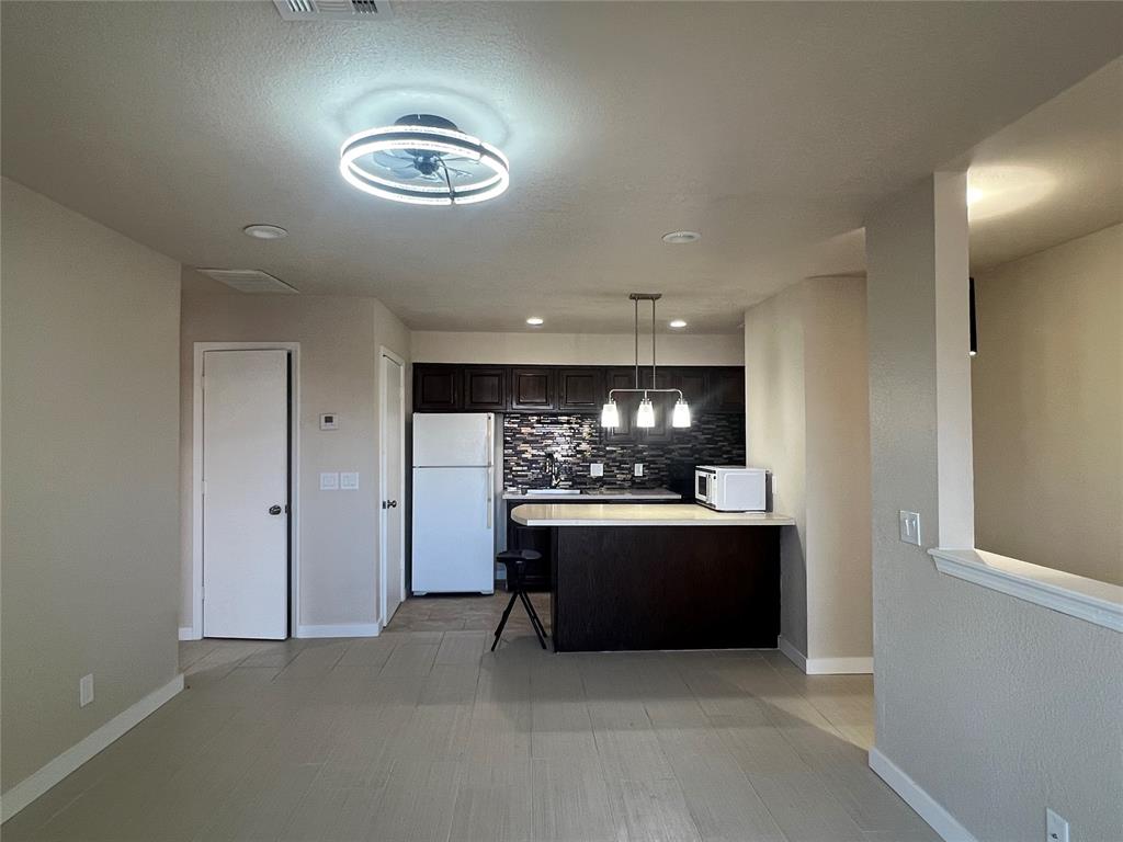 Welcome to this charming and well-maintained upstairs one-bedroom, one-bath condo in the highly desirable, gated community off N. Pennsylvania Avenue. Offering 645 square feet of smart, comfortable living, this move-in-ready home is perfect for anyone seeking convenience, low-maintenance living, or a fantastic investment opportunity.Step inside to a bright and inviting living area featuring updated finishes and plenty of natural light. The cozy layout includes a comfortable living room, a dining space, and a great size kitchen that provides excellent storage and functionality—perfect for everyday living.The spacious bedroom offers room to relax and includes generous closet space. The full bathroom is clean, functional, and designed for easy maintenance. Step outdoors to your private covered balcony, ideal for enjoying a morning coffee or unwinding in the evening.This thoughtfully designed community offers two secure gates, two refreshing pools, well-kept grounds, and an active HOA that takes pride in maintaining the neighborhood. Covered parking and a welcoming courtyard entry add convenience and charm.Located just minutes from shopping, dining, schools, and with excellent highway access, this condo delivers both comfort and an unbeatable location. Whether you're a first-time buyer, downsizing, or seeking a solid rental investment, Unit 6Q is a wonderful opportunity you won’t want to miss! Fresh interior paint/ New tille flooring/ New countertops/ New carpet on the staircaseIncludes refrigerator and a stacked washer & dryer.