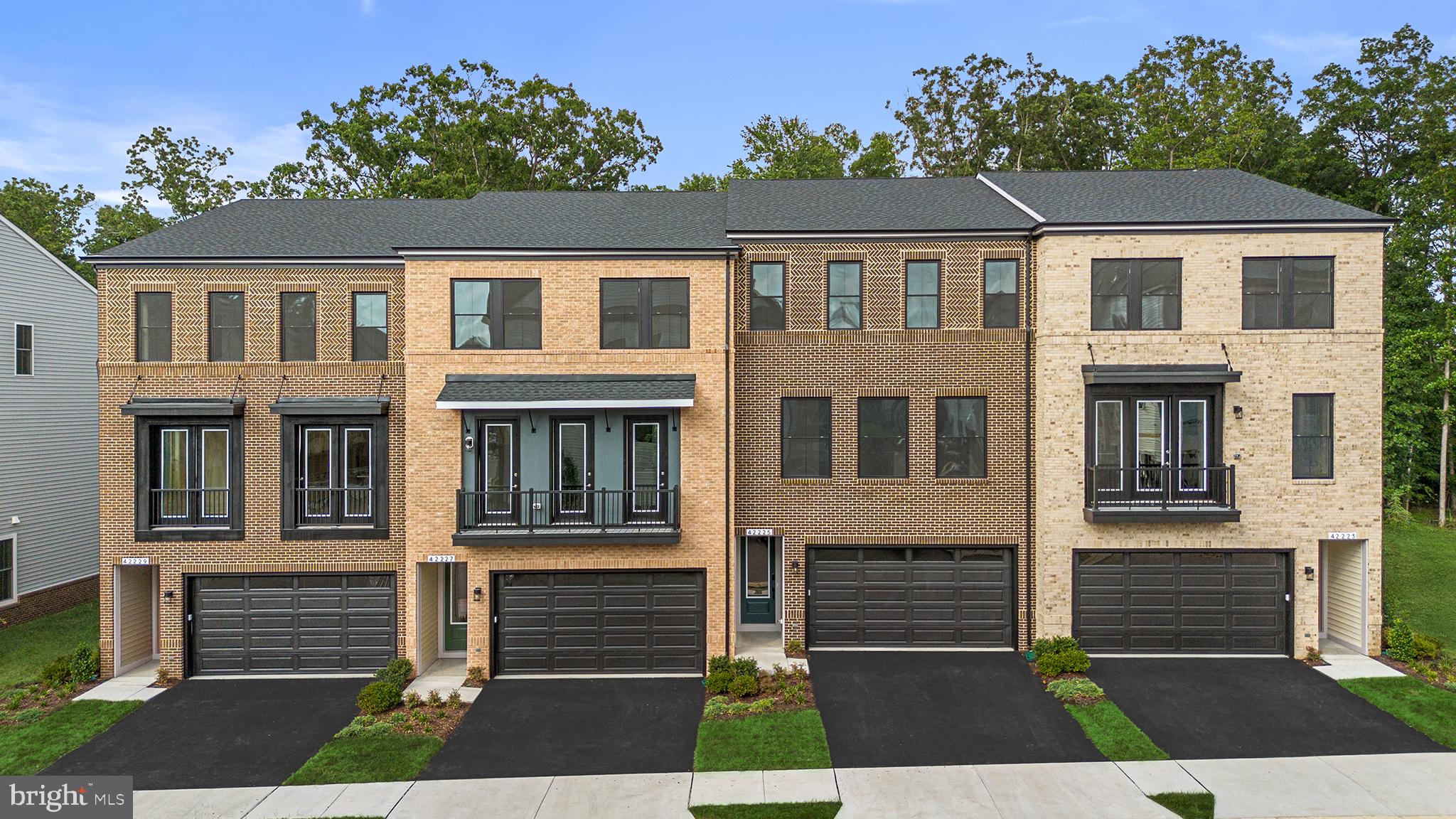 MOVE-IN READY and back on the market, this END TOWNHOME won’t last long. Discover a new constriction townhome at West Park III by Van Metre Homes in Brambleton, VA. Backing to mature trees and a walking trail with visitor parking conveniently located across the street, this never-lived-in home offers privacy and over 2,700 finished square feet across three levels. Homesite 4332 features a 2-car front-load garage with an EV charging circuit, 3 bedrooms, 3 full bathrooms, and 1 half bathroom, along with 9-foot ceilings throughout and Luxury Vinyl Plank flooring in the main living areas. At the center of the home, the open-concept kitchen features an extended island, black soft-close cabinetry with additional storage, white quartz countertops, and GE stainless steel gas appliances, including a a five-burner cooktop with chimney hood and a single wall oven. The great room has an electric fireplace and opens to a spacious deck overlooking the backyard and trees. A separate balcony off the dining room and a flexible nook provide additional indoor and outdoor living spaces. Upstairs, the primary suite features a spa-inspired bathroom with dual vanities, a linen closet, a frameless shower with floor-to-ceiling tile, and a built-in seat. Two additional bedrooms, a full bathroom, and a conveniently located laundry room complete the upper level. The walkout lower-level rec room with a full bathroom offers flexible space for guests, a home office, fitness area, or media room, with direct access to the private backyard. Smart features include a whole-home automation system, smart door lock, smart thermostat, and it is solar-ready. This home offers available closing cost assistance when financing with Intercoastal Mortgage and closing with Walker Title. Being a new build, this home is constructed to the highest energy efficiency standards and comes with a post-settlement warranty.----- Welcome to West Park III, a vibrant neighborhood of dreamy townhomes in the award-winning community of Brambleton, VA. This family-friendly community offers miles of trails, tot lots, parks, pools, highly sought-after schools within walking distance, and so much more at your fingertips. With the bustling Brambleton Town Center just down the street, you can enjoy endless shopping, dining, and entertainment options.-----*NterNow self-touring is available on select homesites at West Park III, no agent or appointment required. Buyers may visit independently during daylight hours. For access instructions and availability, contact Van Metre Homes directly or visit our website.-----*Other homes sites and delivery dates may be available. Pricing, offers, and availability are subject to change without notice. Images, renderings, and site plans are for illustrative purposes only and may not reflect actual homes or features. Additional terms and conditions may apply. West Park III lies within the Airport Impact Overlay District (entirely within 1 Mile Buffer). Due to its proximity to Dulles International Airport, this site is subject to aircraft overflights and aircraft noise. Please see a Van Metre Sales Advisor for details.
