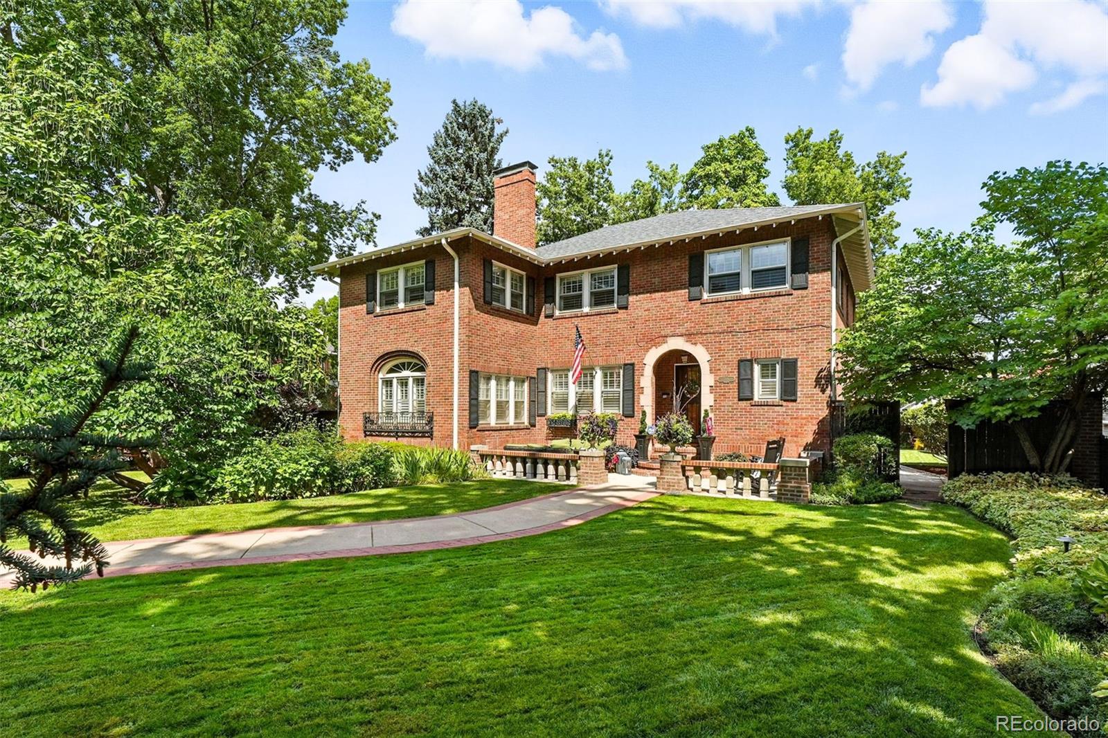 Filled with natural light and thoughtfully renovated, this classic brick home sits on a 10,300-square-foot lot along the picturesque 17th Avenue Parkway.  Set behind mature trees and professionally landscaped gardens, the park-like front yard creates a welcoming approach, while the private backyard offers space for outdoor dining, relaxation, and play.A neutral palette and intentional design choices highlight the home’s architectural character, including crown molding, arched openings, marble tile, picture-frame detailing, polished hardwood floors, and custom built-ins.The main level features a functional layout with a formal living room anchored by a marble fireplace and a window-wrapped sunroom with a built-in swing bed. The kitchen is designed for everyday living and entertaining, appointed with Viking appliances, a double oven, farmhouse sink, generous counter space, and a built-in banquette. A formal dining room sits adjacent for larger gatherings. Two offices - one with an attached bath that allows it to function as a guest suite - plus a mudroom and powder room add flexibility and convenience.Upstairs, the primary suite includes a renovated bath with soaking tub, heated floors, and large-format continuous-vein porcelain tile on the walls and floors. The suite also offers a walk-in closet plus an additional closet for added storage. Three more bedrooms and a marble-tiled full bath complete the upper level, including an oversized bedroom currently used as a lounge and home gym. Original hallway cabinetry provides practical storage, and an upstairs laundry closet adds everyday convenience.Two separate staircases provide access to the basement, which includes a spacious family room with hardwood floors and a decorative fireplace, and ample storage.A detached two-car garage accommodates two full-sized vehicles and offers potential for future expansion to a three-car or attached configuration.