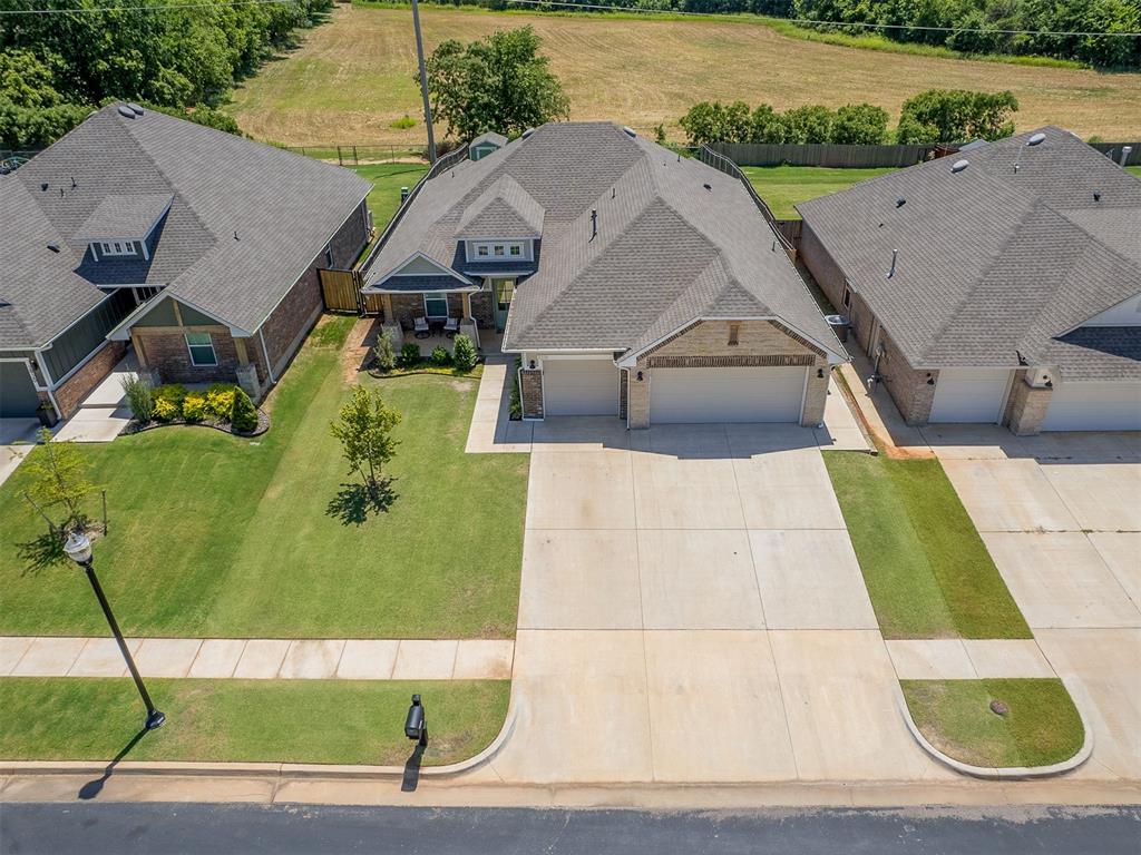 This Edgewater Community gem is giving everything! Located in SE OKC/Moore with peaceful greenbelt/pasture views, this 4 Bed, 2.5 Bath home has the open layout everyone wants. Enjoy the privacy of having no rear neighbors while taking in wide-open views that make your backyard feel even bigger. The kitchen flows right into the dining and living room, featuring a cozy gas fireplace, gray cabinetry, pendant lighting, floating shelves, stainless steel appliances, and a 5-burner gas stove, all with tons of natural light. The dining room's gorgeous modern accent wall is an instant showstopper. You'll love the wood-look tile throughout the main living areas, creating a clean, cohesive look that's both stylish and easy to maintain. The spacious primary suite features double vanities, a soaking tub, separate shower, and a huge walk-in closet. Bonus points for the mudroom, oversized laundry room, garage with a premium polyaspartic floor coating, and an 8x10 storage shed in the backyard. Meticulously maintained and better than new, this home is ready for its next owners. Schedule your viewing today!