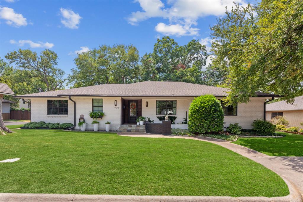 Discover the epitome of stylish living in this stunning single-story residence perfectly situated just one mile from McKinney’s vibrant & historic downtown square. Featuring over 3,000 square feet of impeccably designed living space, this property represents a harmonious blend of classic mid-century modern aesthetics with contemporary updates, making it a rare gem in the market. Step inside to be greeted by gorgeous hardwood floors that extend throughout expansive living, dining, traffic areas, & bedroom spaces offering a handsome & practical flooring choice that is ideal for both relaxed living & entertaining. The charming built-ins & an abundance of storage solutions seamlessly complement the sleek design elements and painstakingly curated updates. A private study, featuring sliding, barn-style, glass pane doors, promises a quiet space for work or relaxation, underscoring the home's functional versatility. The heart of the home lies in the well-appointed, island kitchen, showcasing both style & practicality, and is ready to inspire culinary creativity. Highlighted by double ovens, a gas cooktop, generous storage & pantry space, the kitchen includes a deep, single bowl stainless steel sink, leathered granite counter tops, & classic white subway tile backsplash with a custom niche above the range to keep cooking essentials handy. The split floor plan offers four spacious bedrooms, including a secluded primary suite designed to offer privacy & comfort. Each of the two and a half baths is tastefully updated, reflecting contemporary elegance. With an oversized two-car, side-entry garage, this home blends mid-century modern design with thoughtful updates and immaculate maintenance. Outside, a professionally designed & maintained landscape showcases a picture of tranquility. Painted brick exterior, accented with charming window boxes, exudes character & curb appeal while the private, shaded backyard serves as a serene oasis for outdoor gatherings or quiet afternoons.