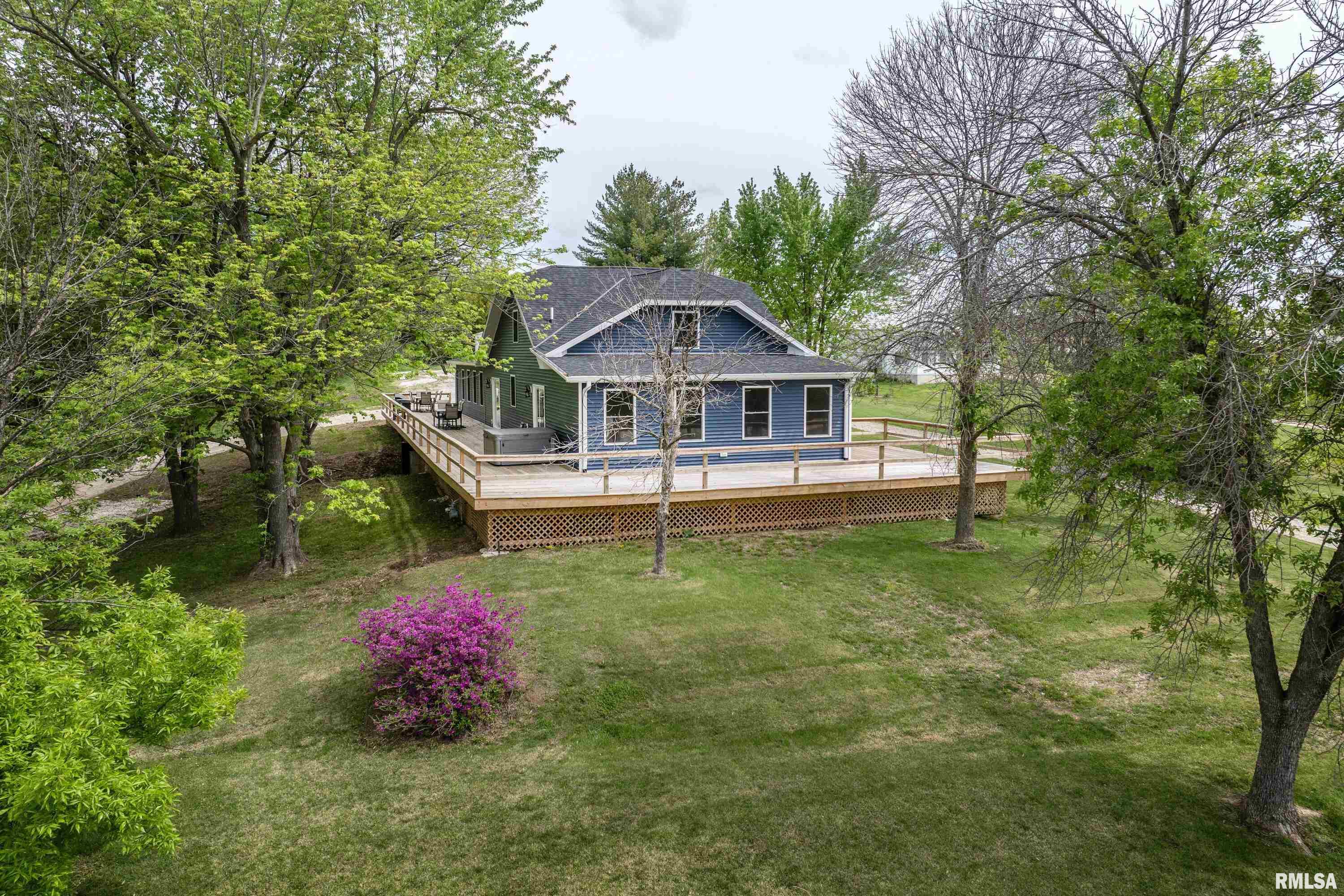 Don't sleep on this one folks, this home was custom designed to take your breath away! The spacious 5 bedroom, 3 bath home is situated on just over 2 acres and has been renovated from top to bottom making it the epitome of luxury and style. You can feel the grandeur from the moment you walk through the doors into the expansive living space adorned with varying sized solid hickory flooring, bright LED lighting and a modern 60' recessed electric fireplace. You'll flow seamlessly to the chef's dream kitchen featuring crisp white quartz countertops, custom stainless appliances including a 48" gas range with matching range hood, 5' sink with all the workspace extras, and anchored by a massive 10' island with seating. The primary suite is the sanctuary you've been dreaming of with its own private sitting room, an immense master bath with 2 separate vanities as well as a large walk in shower, and a 10x12 dressing room/walk in closet. It also offers private sliding door access to the expansive deck that flanks nearly the entire perimeter of the home for that perfect morning coffee watching the sunrise! You'll love the convenient main floor laundry and the additional main floor bedroom and full bath. Upstairs you have another 3 large bedrooms all with generous closet space and new paint, flooring and fixtures and a third totally updated full bath. If what yo'll find inside wasn't enough, there are 2 outbuildings for all your storage needs and plenty of parking. This one is a must see!