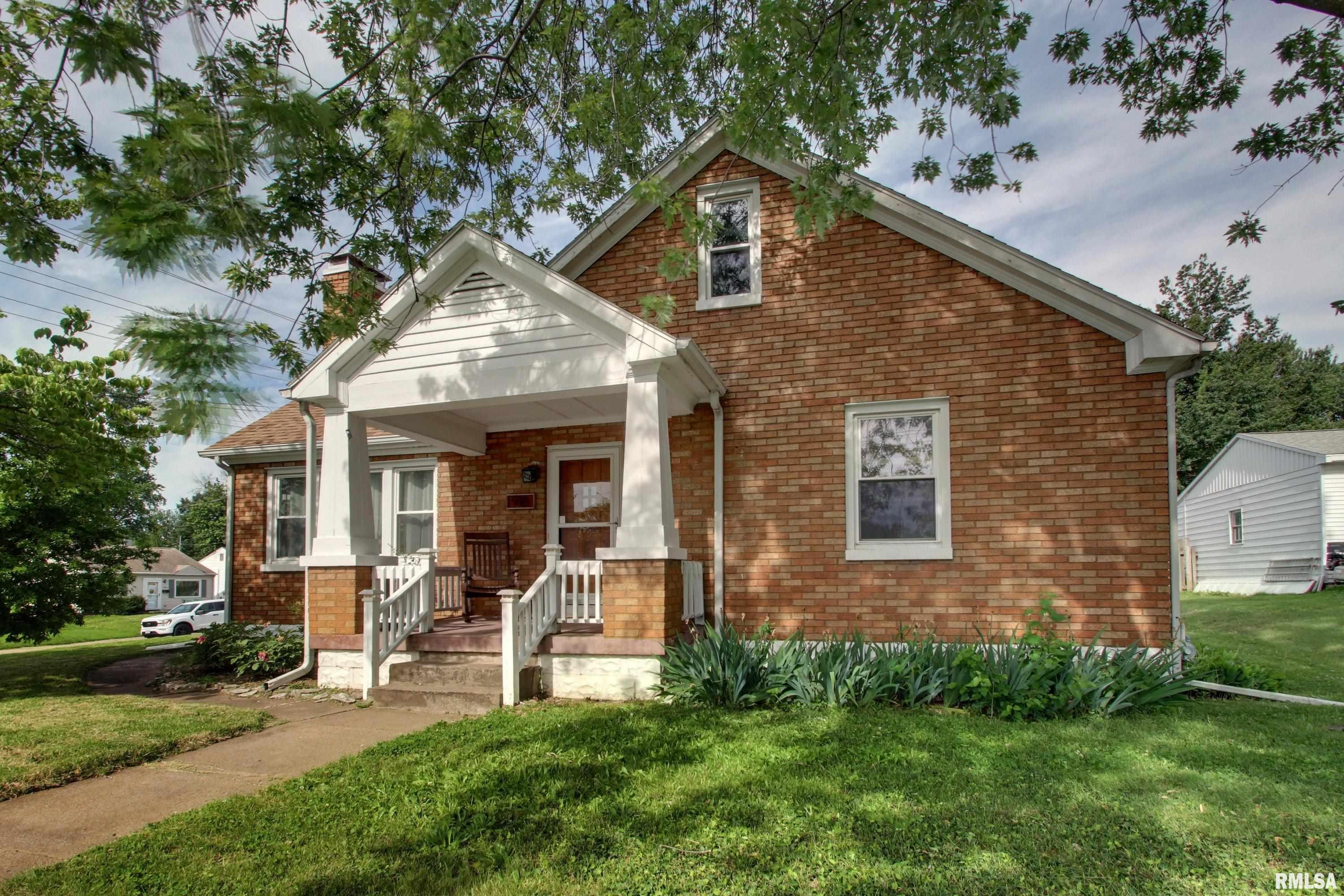 Charming all-brick bungalow with classic character and flexible living space throughout! This 3-bedroom, 2 full bathroom home features two bedrooms on the main level and a spacious third bedroom upstairs.  Beautiful hardwood floors run through the main-level bedrooms, living room, and dining room, creating warmth and timeless appeal. The functional layout offers comfortable everyday living with plenty of natural light and inviting spaces to gather.  The basement adds exceptional versatility with a secondary living room area, full bathroom, garage access, and an additional private room currently used as a workshop — ideal for hobbies, a home office, workout space, or extra storage.  Step outside to enjoy the fully fenced flat backyard, perfect for entertaining, pets, or outdoor activities. A patio space above the drive-in garage provides another great spot to relax or host family and friends.  A wonderful blend of charm, functionality, and usable space both inside and out!