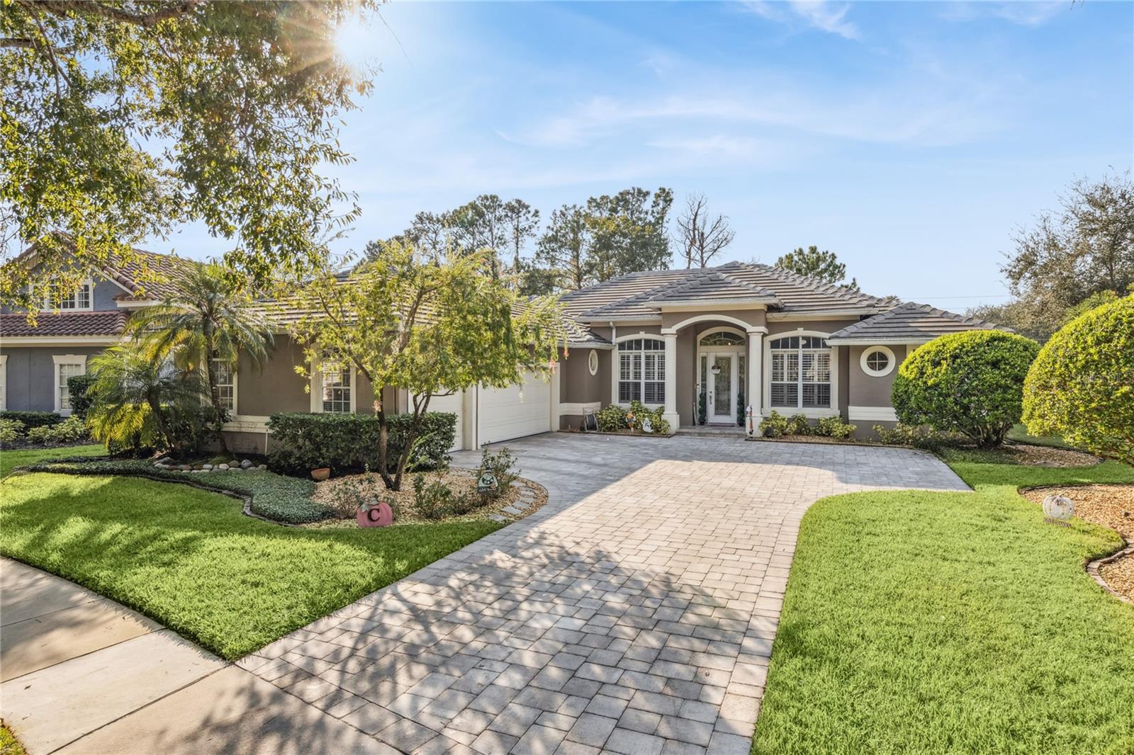 Experience refined living in this beautifully remodeled, custom-built residence in the Bridgewater Club neighborhood of Heathrow. This 4-bedroom, 2.5-bath luxury home masterfully blends elegance, comfort, and timeless design. A three-way split floorplan ensures privacy for both residents and guests. Inside, you’ll find plantation shutters, crown molding, and custom built-ins, paired with a spacious family room centered around a gas and wood-burning fireplace. The gourmet kitchen is designed for both everyday living and entertaining, featuring stainless steel appliances, a gas range, and ample counter space for culinary enthusiasts. Working from home is made easier with 2 private home offices. Step outside to your private oasis: a covered lanai overlooking a screened, gas-heated pool, perfect for year-round relaxation. The home’s exterior also offers a three-car garage and a brand-new brick paver driveway, providing both beauty and functionality. A new tile roof installed in 2021 offers added peace of mind — a true move-in-ready advantage in one of Central Florida’s most desirable communities.  This is more than a home — it’s an elevated lifestyle.  Heathrow is Lake Mary's Premier Golf and Country Club Community. It is a private gated community featuring 24-hr. manned security gates, plenty of amenities and zoned to highly rated schools. Enjoy fun activities at Sawyer Lake Park with a large clubhouse, playground, baseball diamond, multi-purpose ball field, lighted basketball court, covered pavilions for hosting larger gatherings and fishing from the pier. Residents can join the Heathrow Country Club and The Legacy Club for the ultimate golfing & dining experience. Members of the Athletic Club have access to 13 tennis courts for year-round play, an Olympic-sized swimming pool overlooking Lake Corso and a fitness facility offering personal training, group classes & massage therapy.  Heathrow is conveniently located near Top Golf, a brand-new medical park, shopping, dining, and entertainment at Colonial Town Park & Seminole Town Center mall. The Seminole Cross recreational trail is close by for bike riding, running and walking. Easy access to I-4, SR417, SR429, and Disney Parks. COME & ENJOY THE HEATHROW LIFESTYLE!  This property may be under audio/video surveillance.