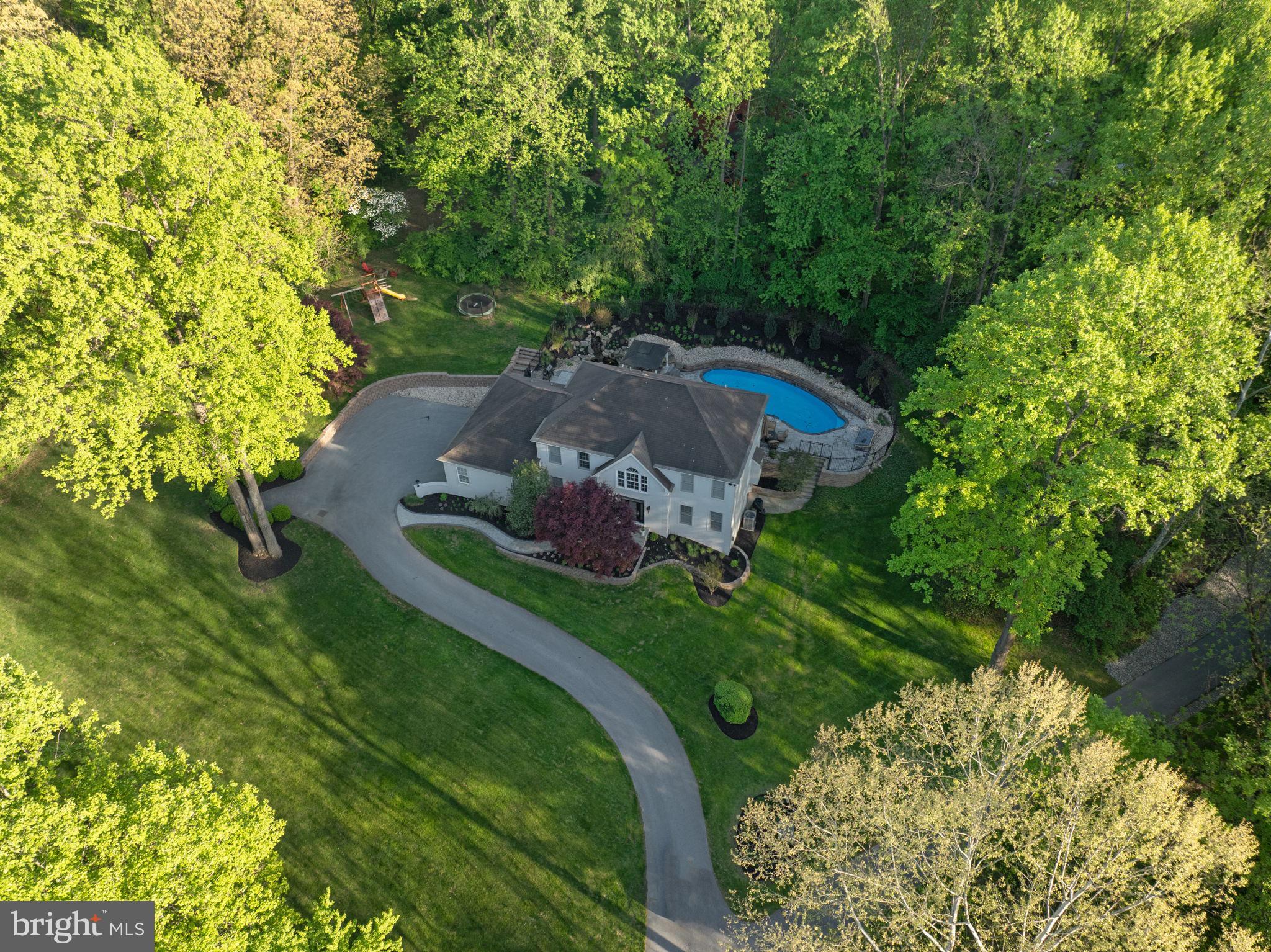 West Chester School District! A beautiful custom-built home situated on 1.3 private acres in the scenic hills of East Bradford Township, just minutes west of West Chester Borough & walking trails. This Updated home offers a thoughtful floor plan with 3 bedrooms and 2 full baths on the second floor, plus a finished walkout lower level featuring a 4th bedroom, full bath, recreation/family room, custom cabinetry, French doors, and generous storage. The main level features porcelain flooring thru out, 2-story foyer, large first-floor office, 2024 updated custom kitchen cabinetry, Sub-Zero refrigerator, new countertops, wine cooler, island workspace, breakfast room, extensive trim accents, wainscoting, plantation shutters, tile flooring, and a gas fireplace. The spacious primary suite offers a tray ceiling, hardwood flooring, sitting area, walk-in closet, and tile bath with soaking tub, double vanity, and separate shower. Built for entertaining, the outdoor space includes a heated in-ground pool with spa, all new bluestone paver patio, new pavers around the pool & front walkway, paver firepit area, beautiful waterfall, shed, and peaceful natural surroundings. Additional highlights include a heated 3-car side-load garage and full-size second-floor laundry.Enjoy quick access to Route 202, Route 30 Bypass, PA Turnpike, train station, and major commuting routes. Just down the street from Harmony Hill Nature Area for walking, hiking, biking, and outdoor activities. A rare private setting in a highly desirable West Chester location.
