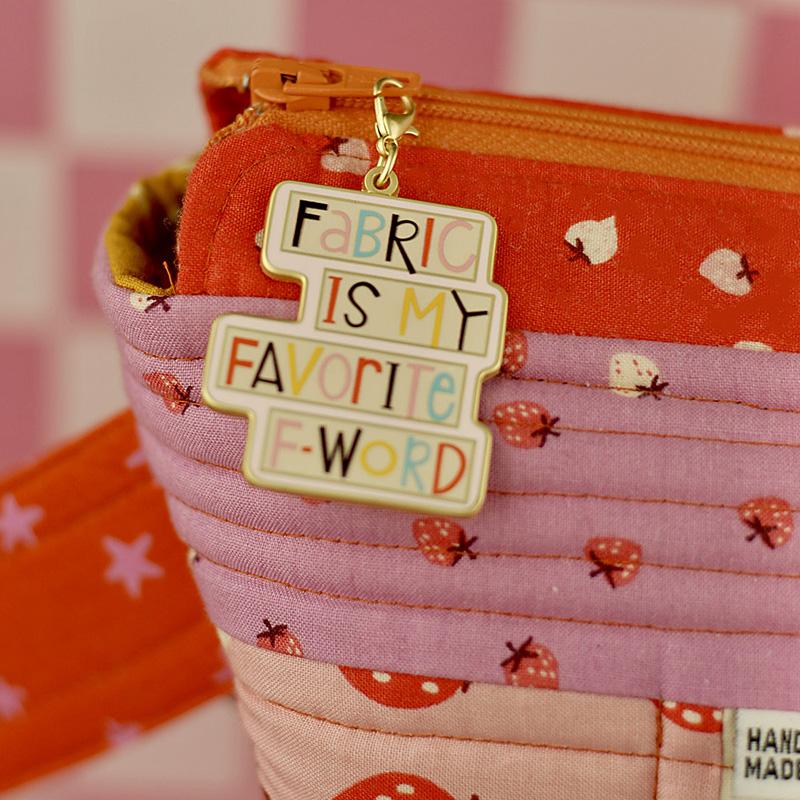 Fabric Is My Favorite F-Word enamel zipper charm attached to project bag
