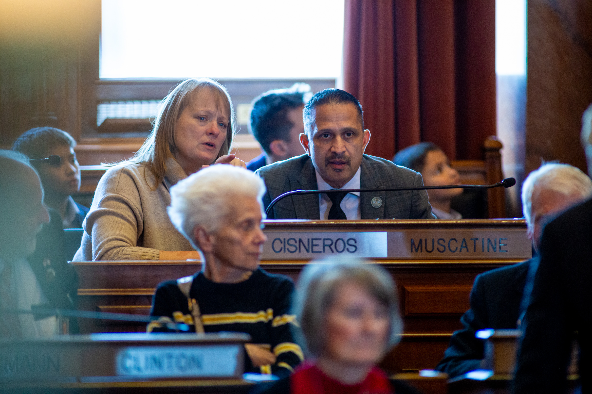 Rep. Mark Cisneros (R Muscatine) speaks with his aide as the session starts.