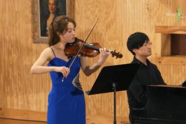 Violinist plays beside pianist
