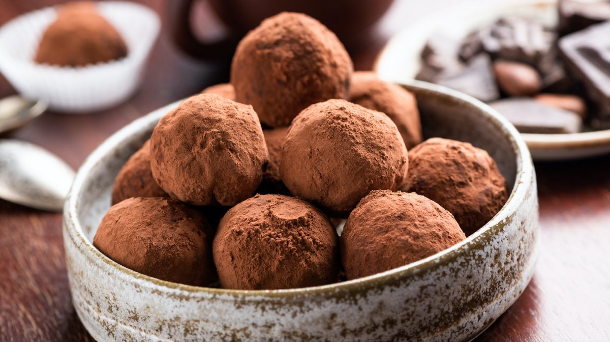 cocoa dusted bourbon balls in a dish