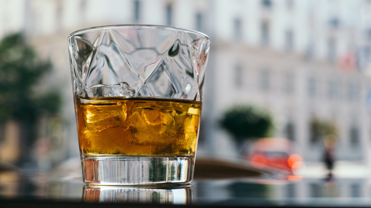 Glass of whisky on a table outdoors