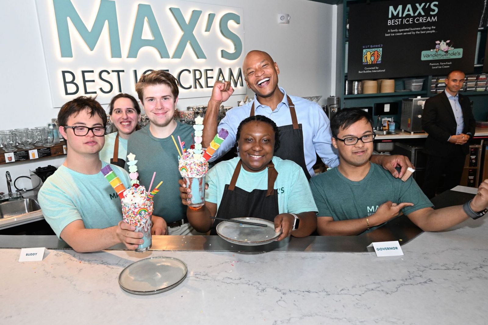 Governor Moore stands behind the counter at Max's Best Ice Cream, a local small business in Bethesda that is co-owned by Best Buddies International.