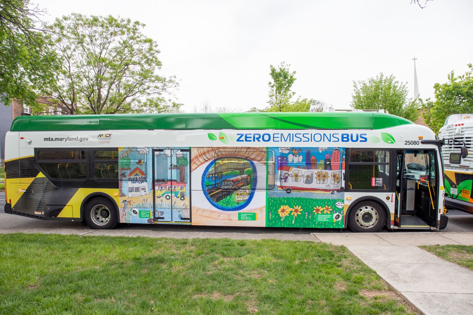 An MTA Zero Emission Bus with finalists' artwork on the side.