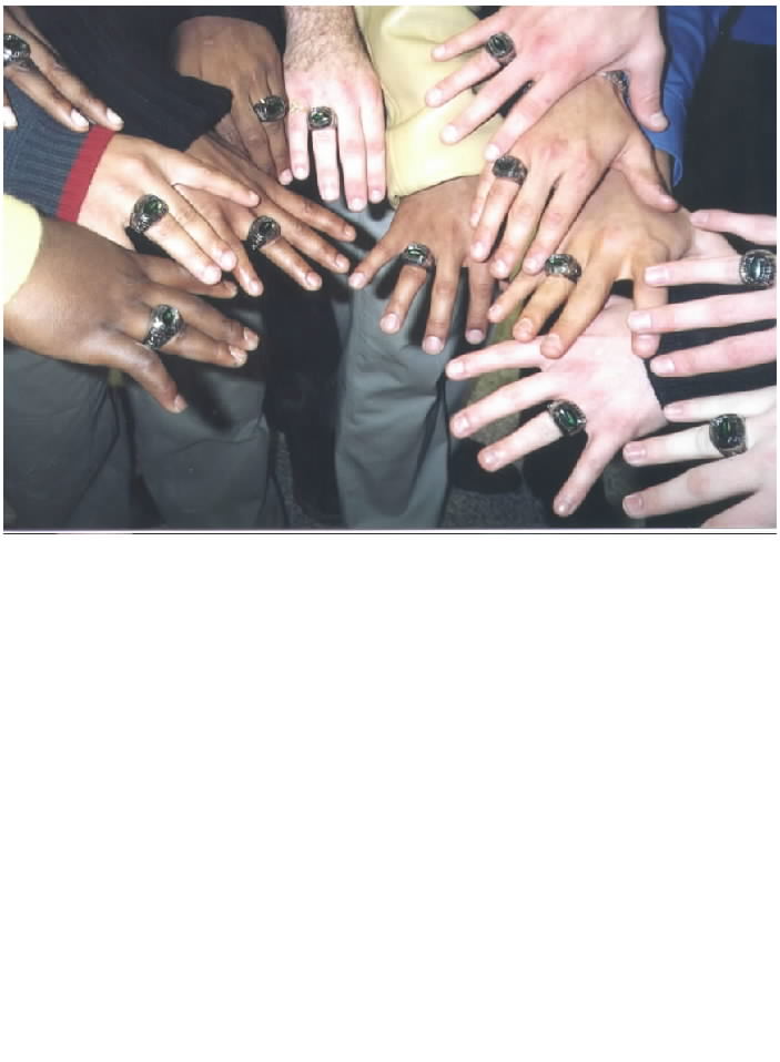 PROUD MEMBERS OF THE 2001 HAWKS SHOW OFF THEIR CHAMPIONSHIP RINGS