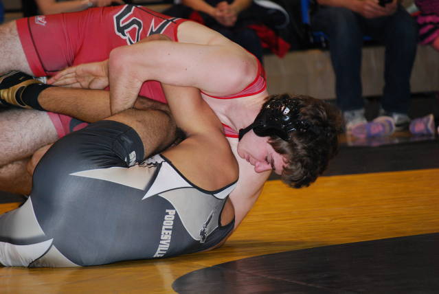 Junior Blake Adkins prepares to pin Poolesville's Aden Bhagwat.