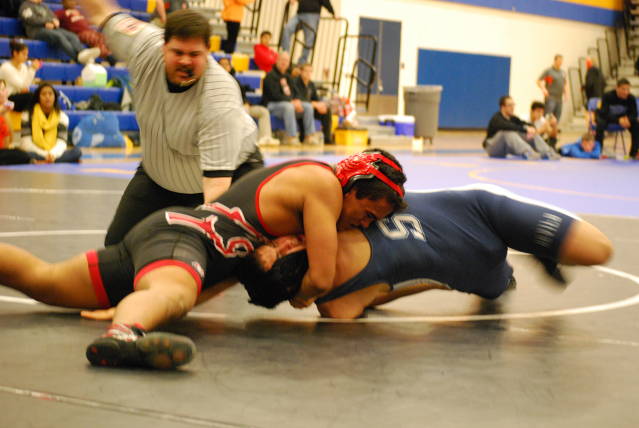 Danny Henn rolls one of his opponents on to his back