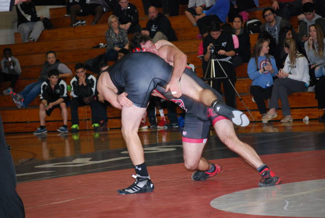 Henry Canova drives his North West opponent to the ground.
