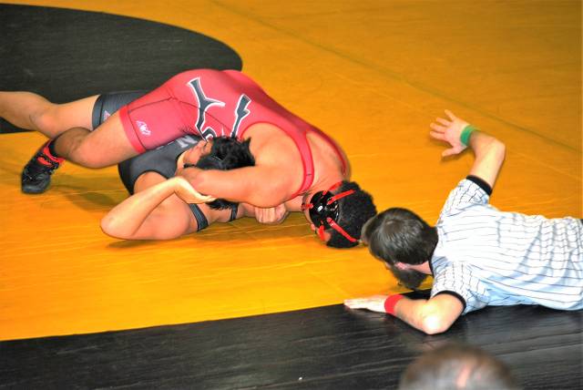 Senior Tyler Enceneat pins his Northwest opponent.