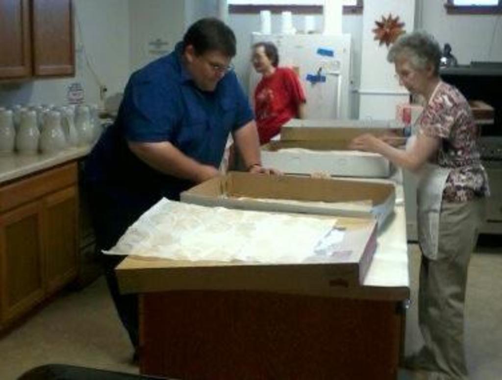 Matt Wiegand, Diane Olson, Pat Misukanis working in kitchen