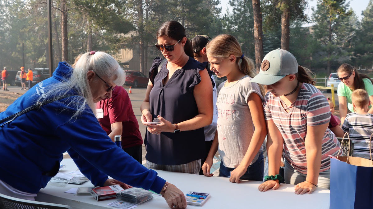 Peggy signing kids up for VBS.