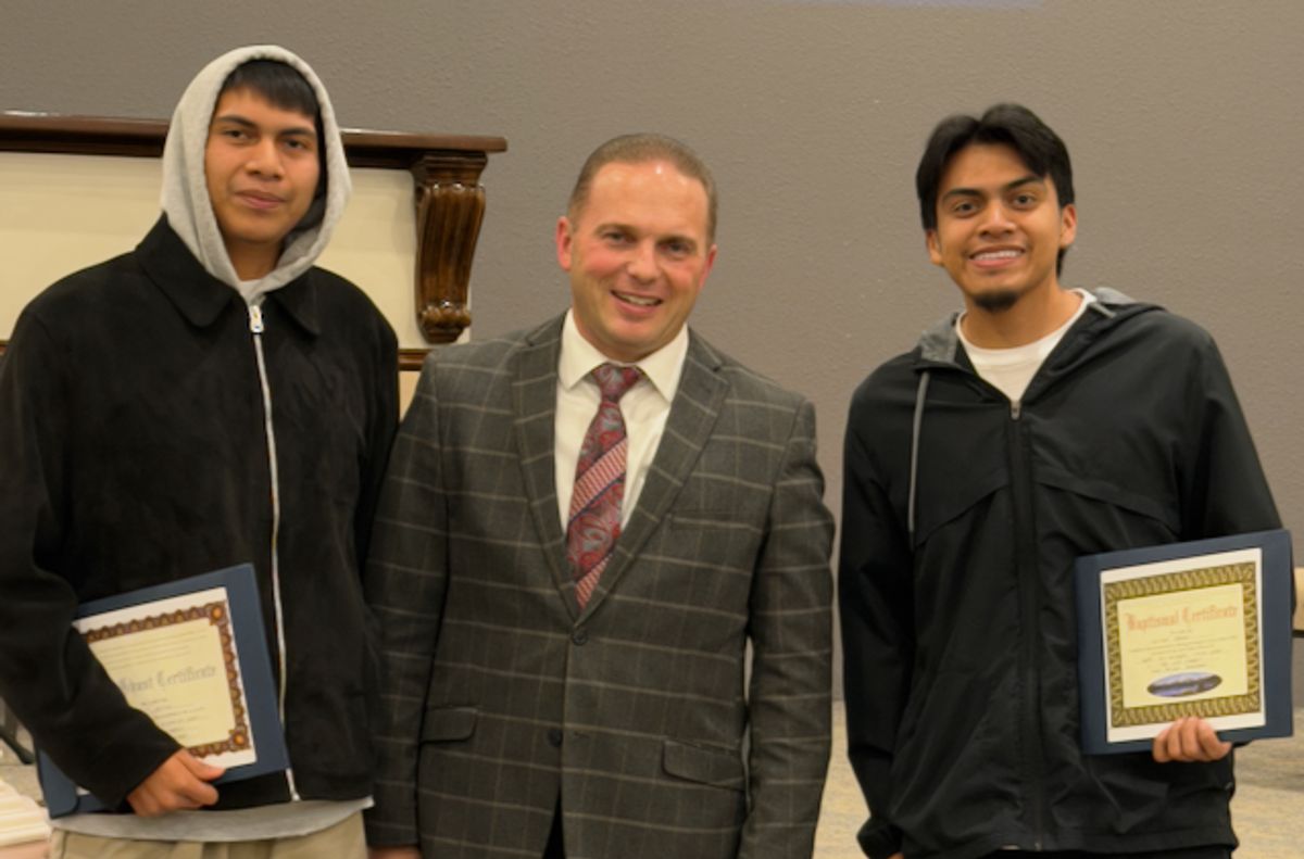 Pastor Bohannon Presents a Baptism Cert to Bro Jaret Bravo and Manny Bravo at TLC