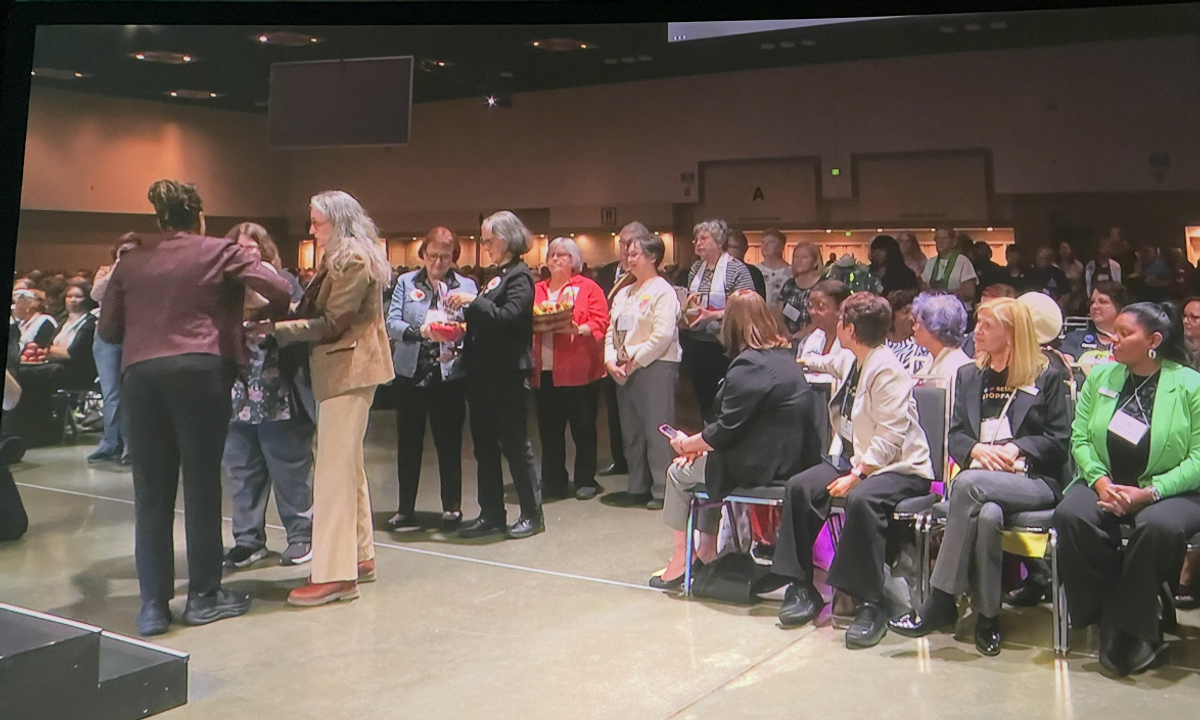 Treasurer Julie Noel and President Wendy Campbell prepare to give our HTC offering of abundance