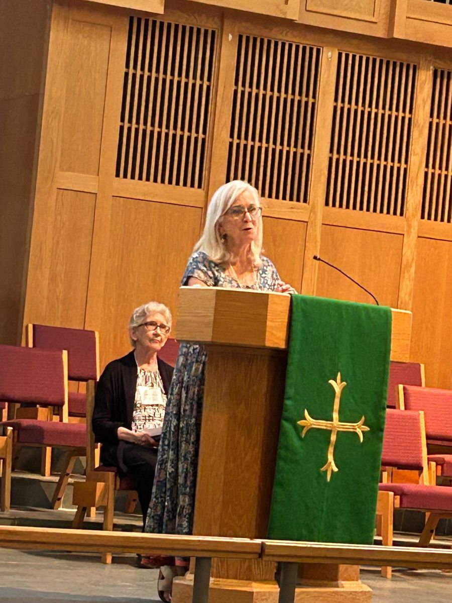 Doris Marshall looks on as Marsha Faram greets the Metro East District.