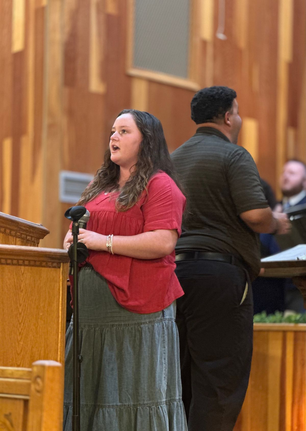 Miss Emily Hall singing the lead in “I Made It By Grace.”
