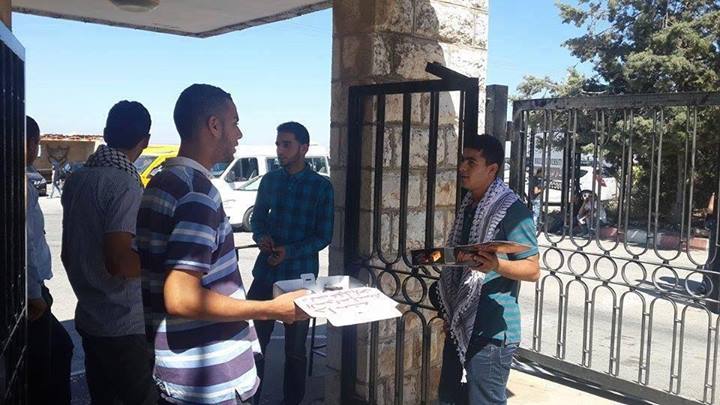 University students in Birzeit University distribute sweets in celebration of the kidnapping of the three Israeli teenagers. Source: idfblog.com