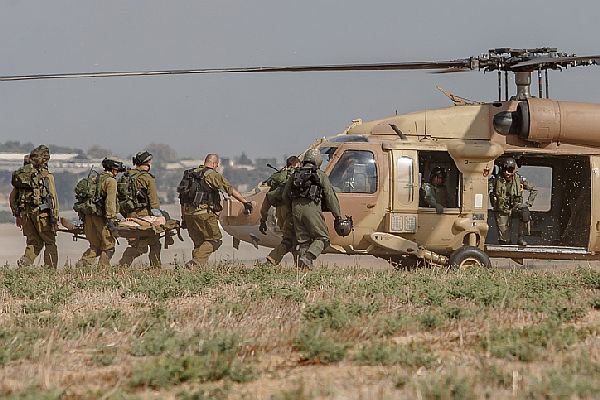 An injured Israeli soldier is evacuated by helicopter from near the Israeli border with Gaza Strip on July 21, 2014, following heavy fights between Israeli soldiers to Palestinian militants. The Israeli army Spokesperson's Unit said two terror cells infiltrated into Israeli territory Monday morning through a tunnel in the northern Gaza Strip. Observation units identified the terrorists; Israeli Air Force planes attacked and hit the first cell. Israeli army forces deployed to the area killed some 10 terrorists from the second cell. Photo by FLASH90