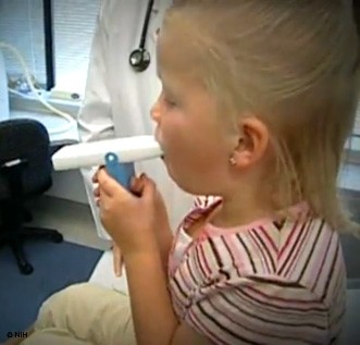 Child using a peak flow meter