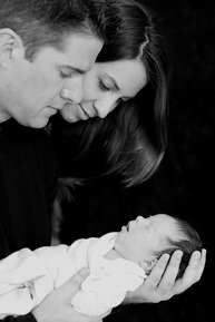 oil portrait from a photo of 2 parents looking at their baby