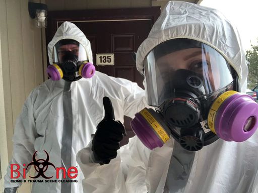 Image shows Bio-One technicians in full protective gear. Image shows Bio-One technicians in full protective gear.