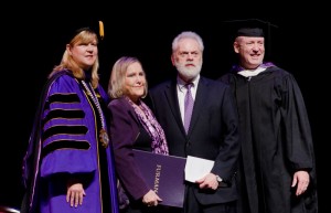 Furman president Elizabeth Davis and trustee Mike Riordan presented the Bell Tower Award to Rubye and Wayne Reid (center).