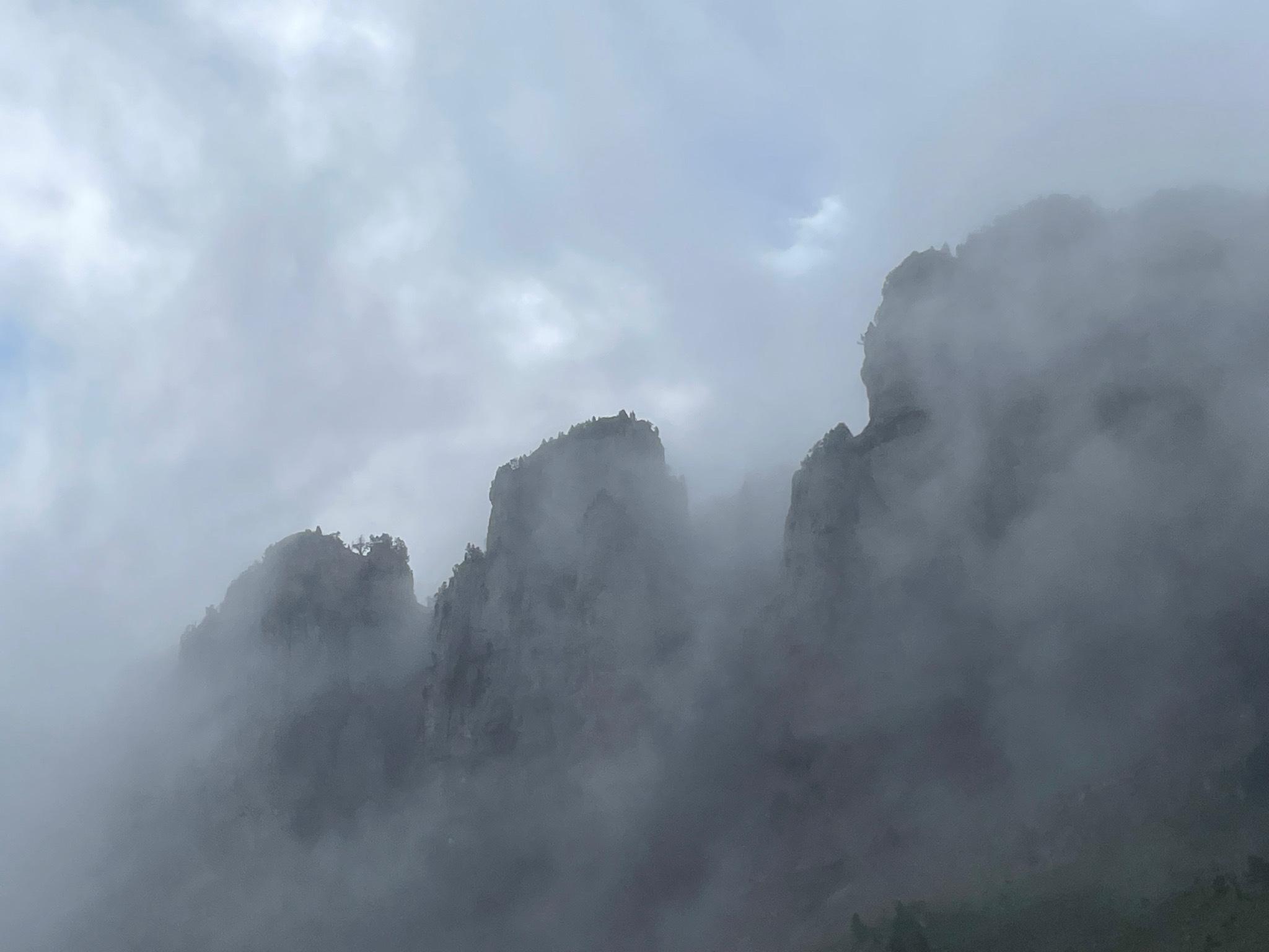 rocky cliffs in dense fog