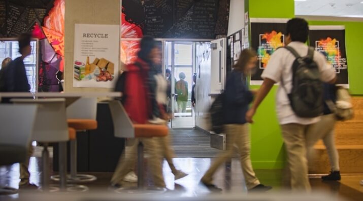 students walking across bright hallway