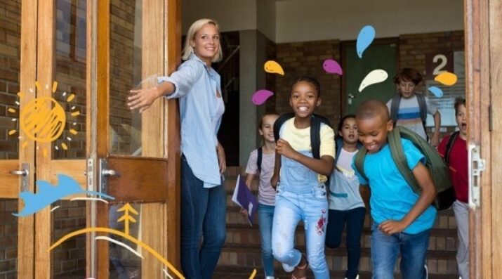 happy students leaving school building