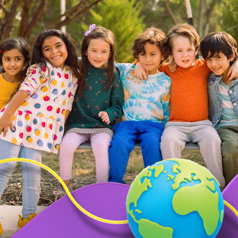 Children sitting together with a globe