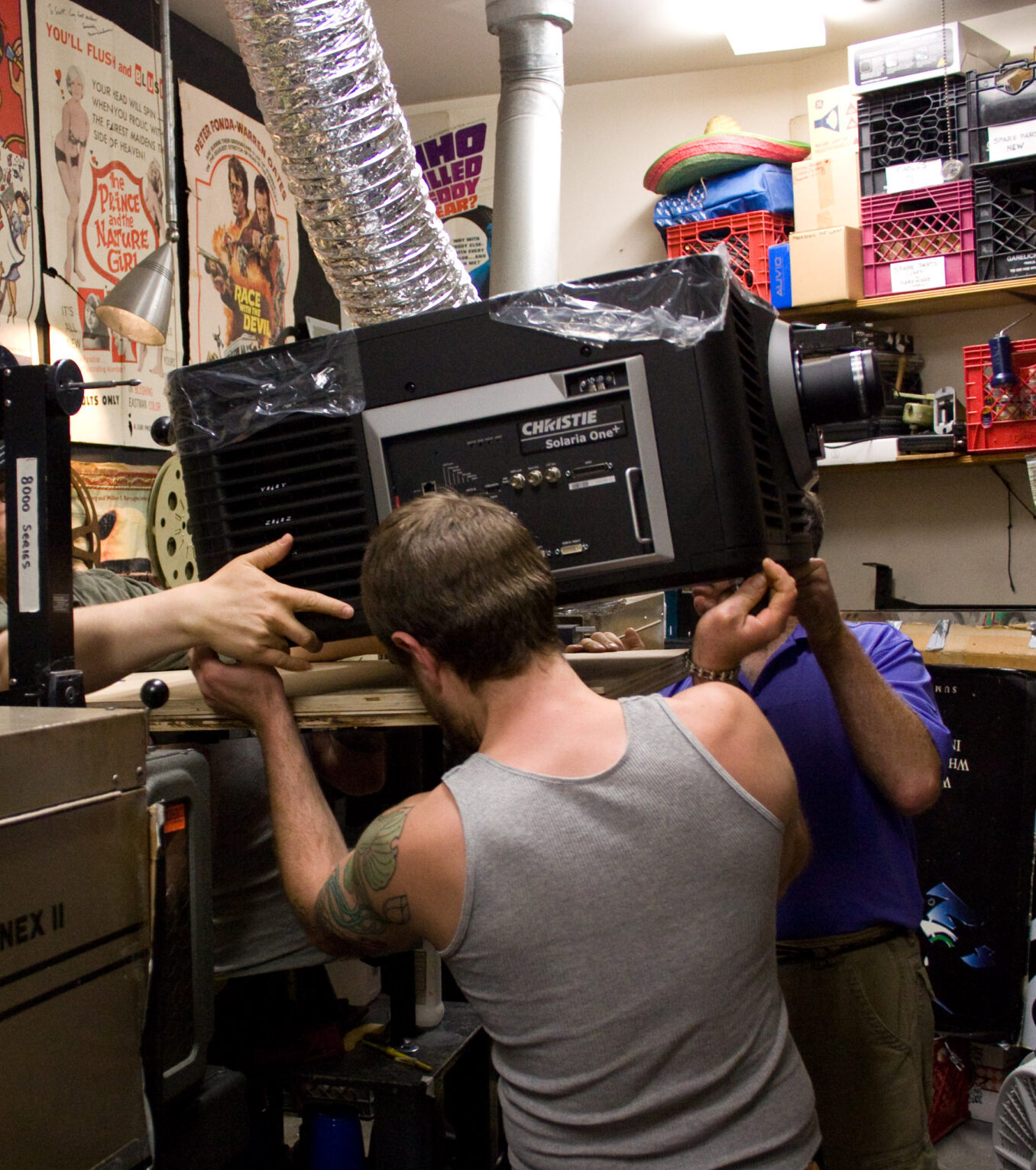 The Brattle staff put the latest laser projector in place